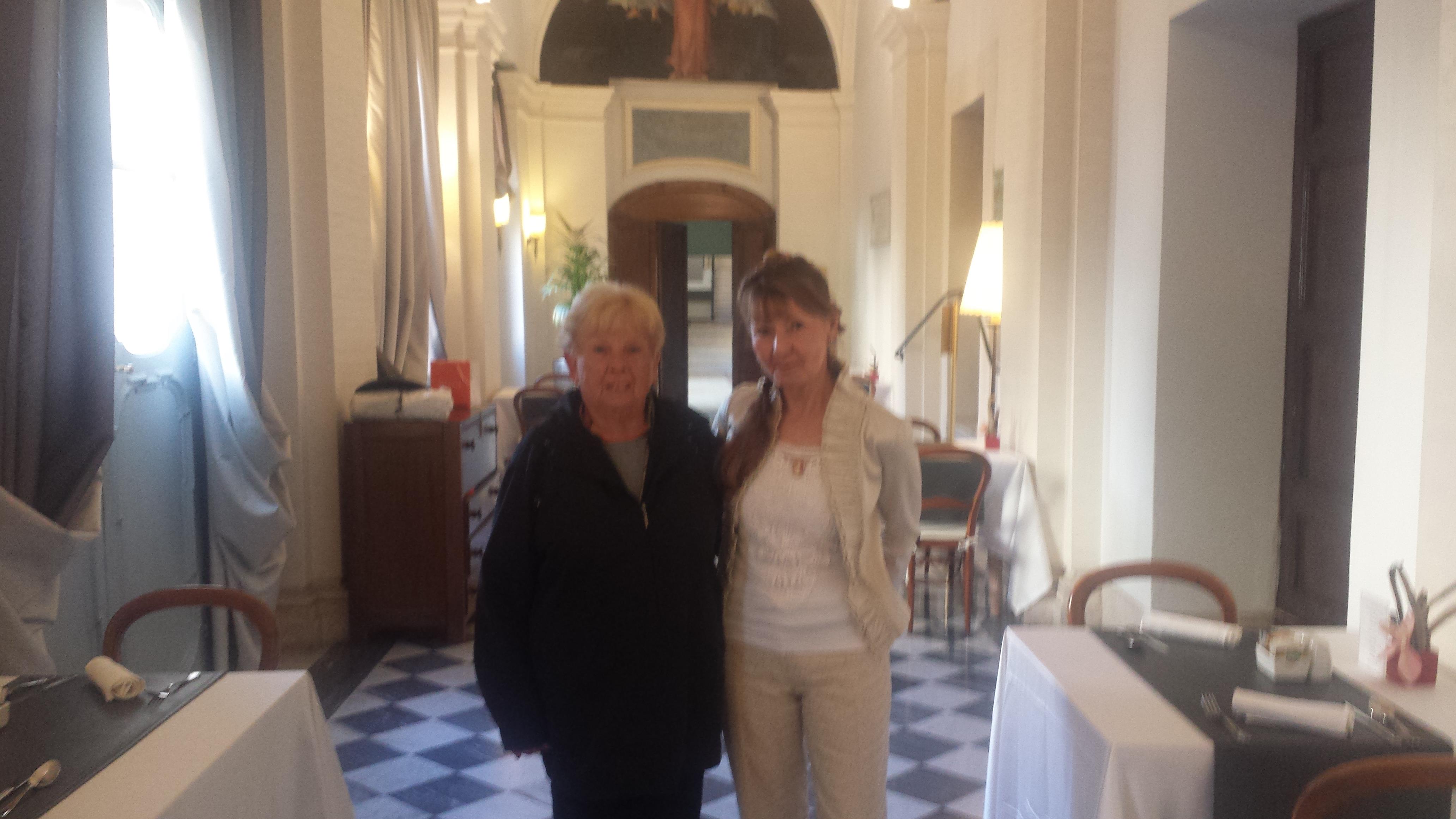Two women standing in a hallway
