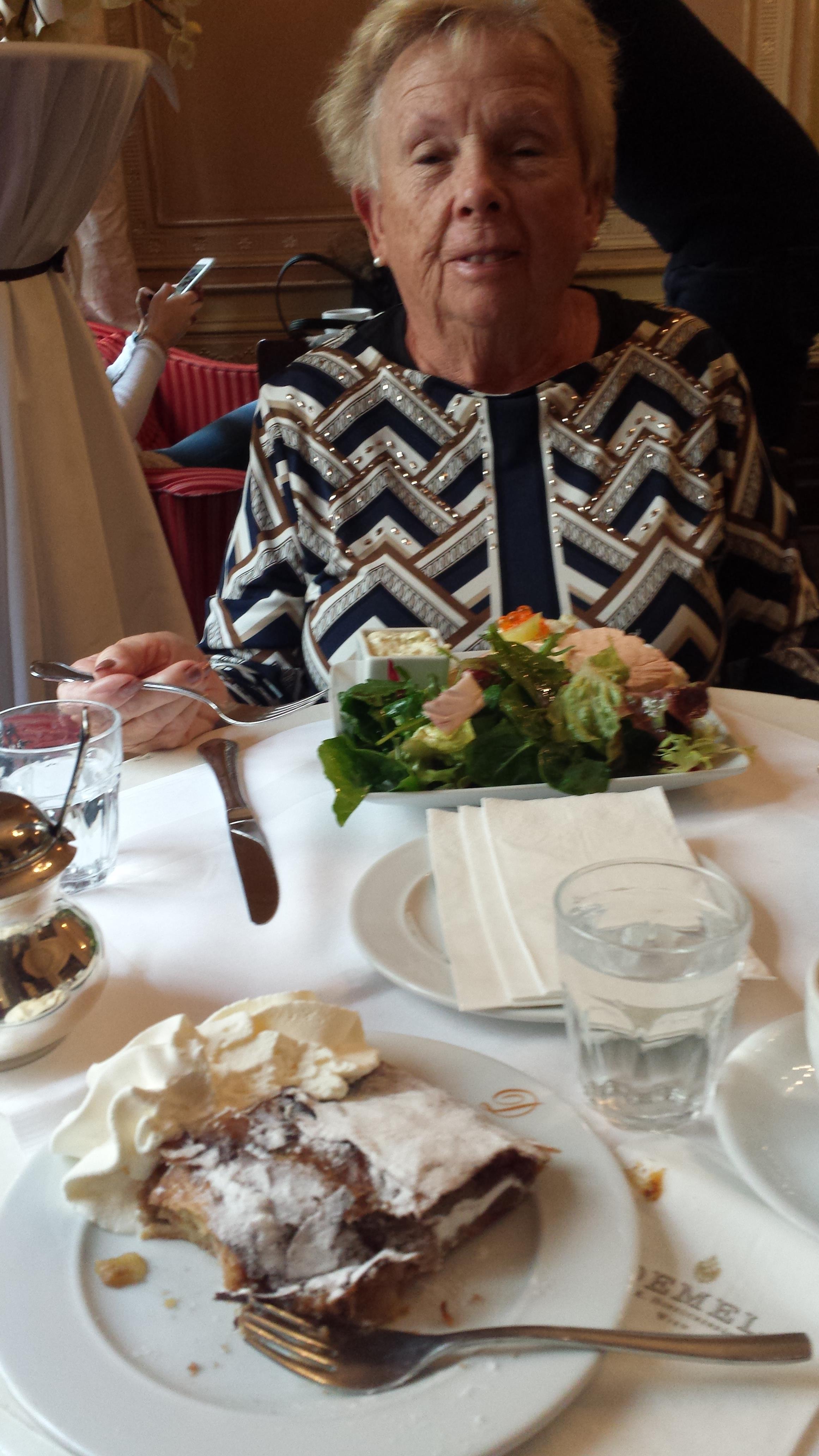A woman sitting at a table with food on it