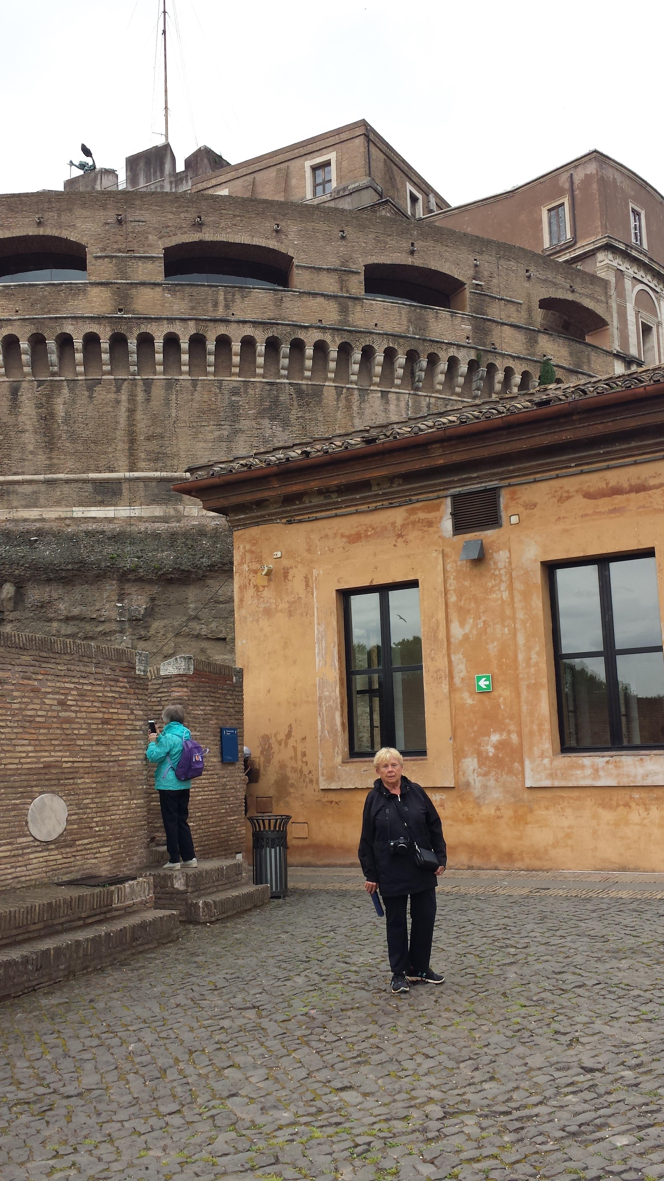 A woman standing in front of a building