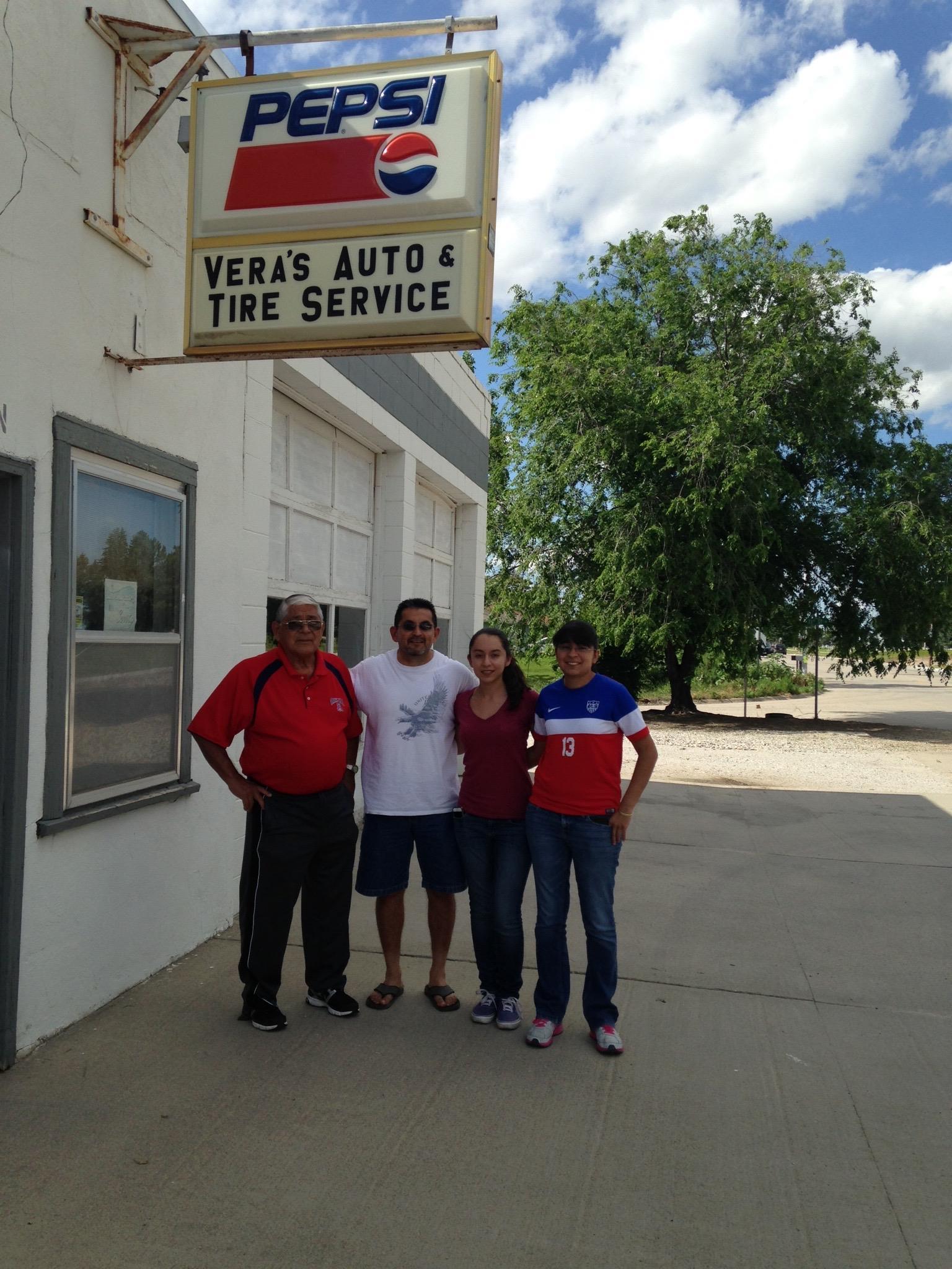 A group of people standing in front of a sign
