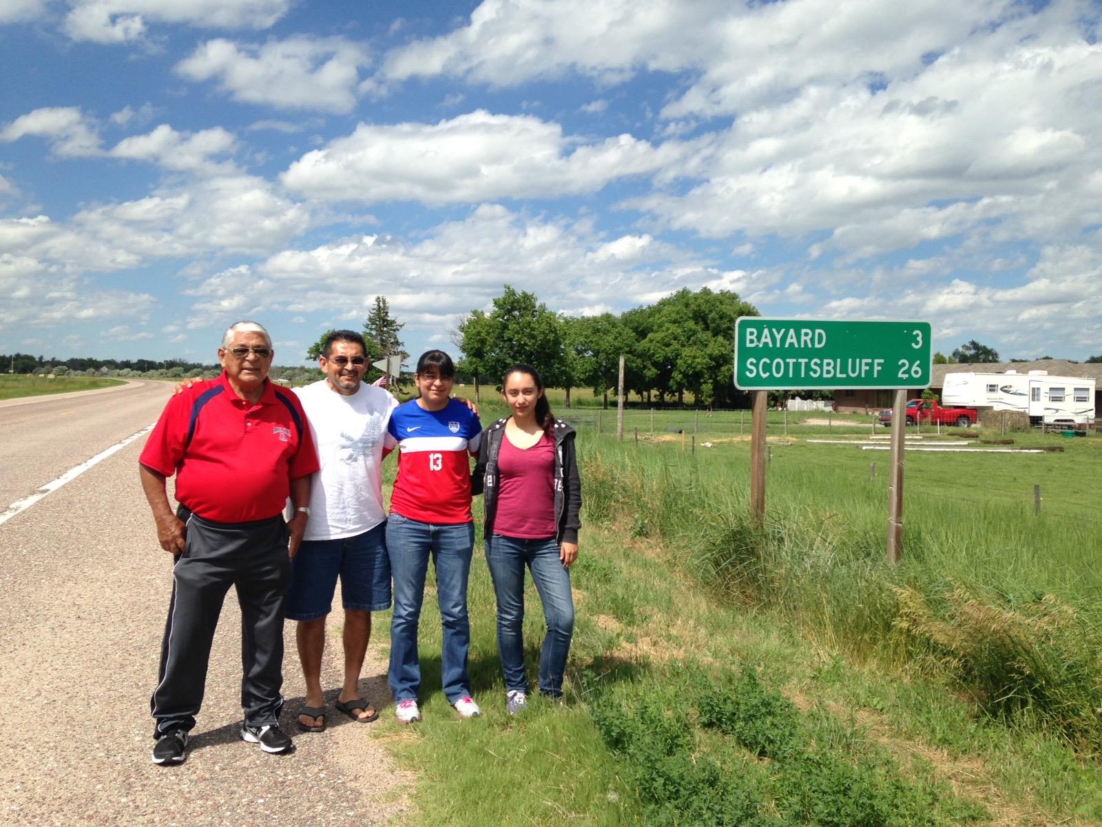 A group of people standing in front of a sign