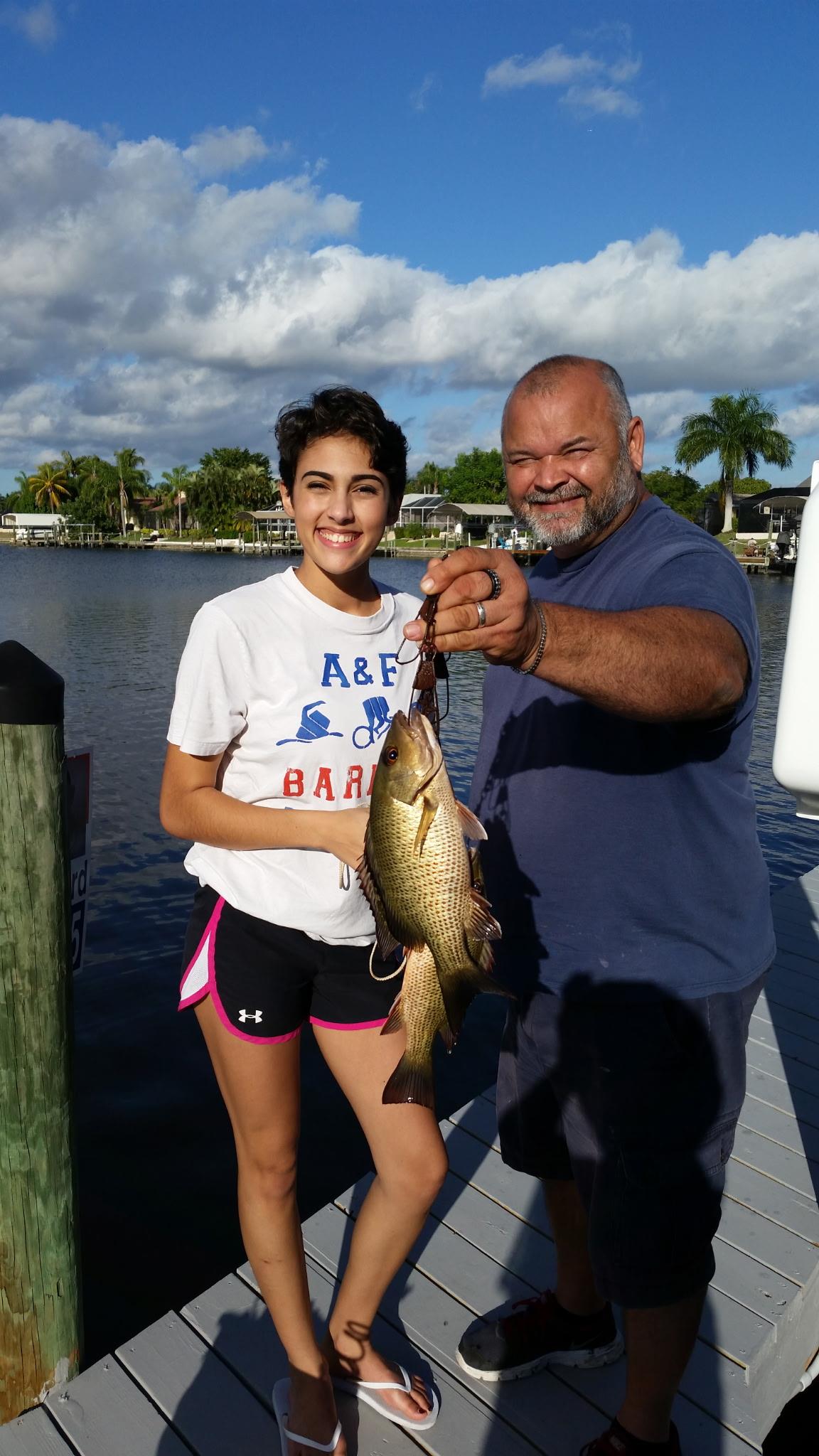 A man and woman holding a fish