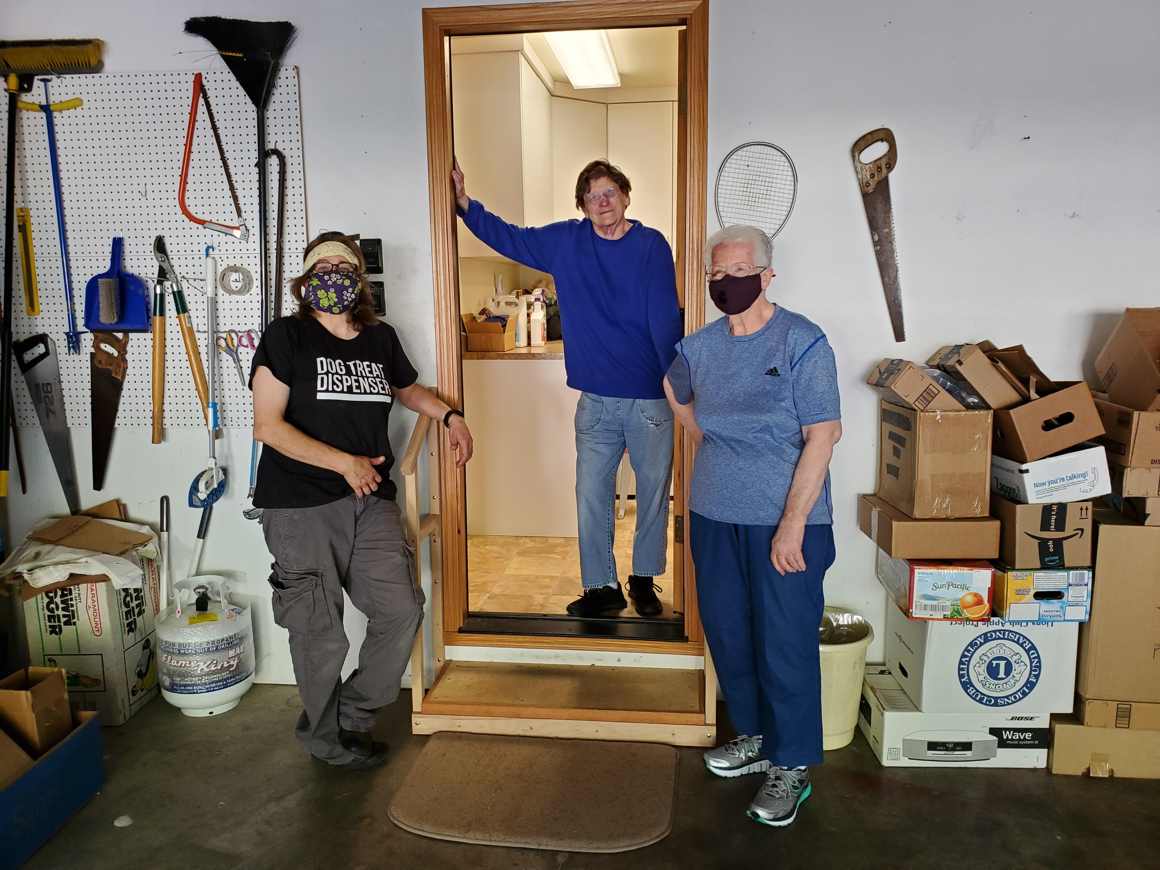 A group of people standing in a room with a door open