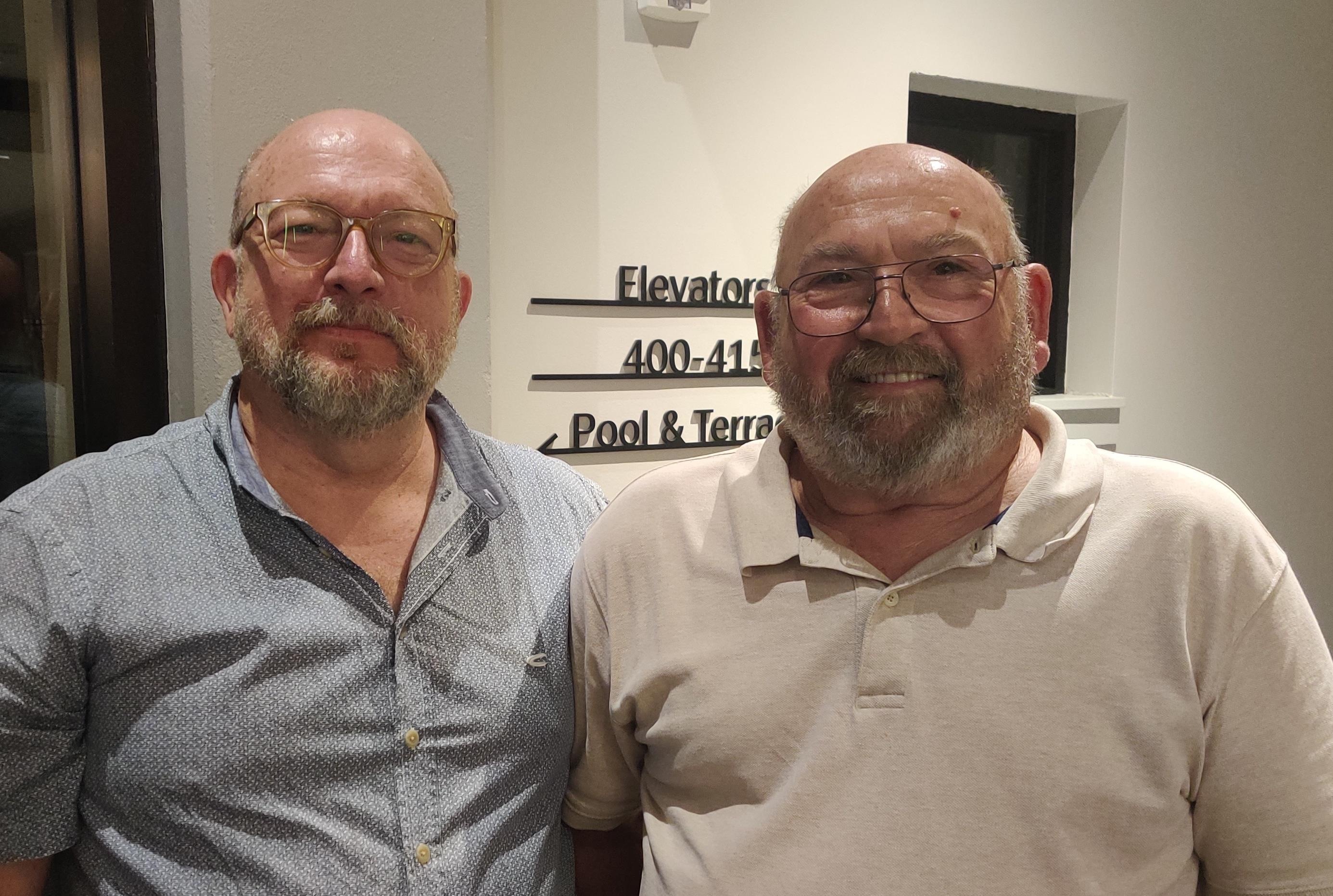 Two men standing together smiling