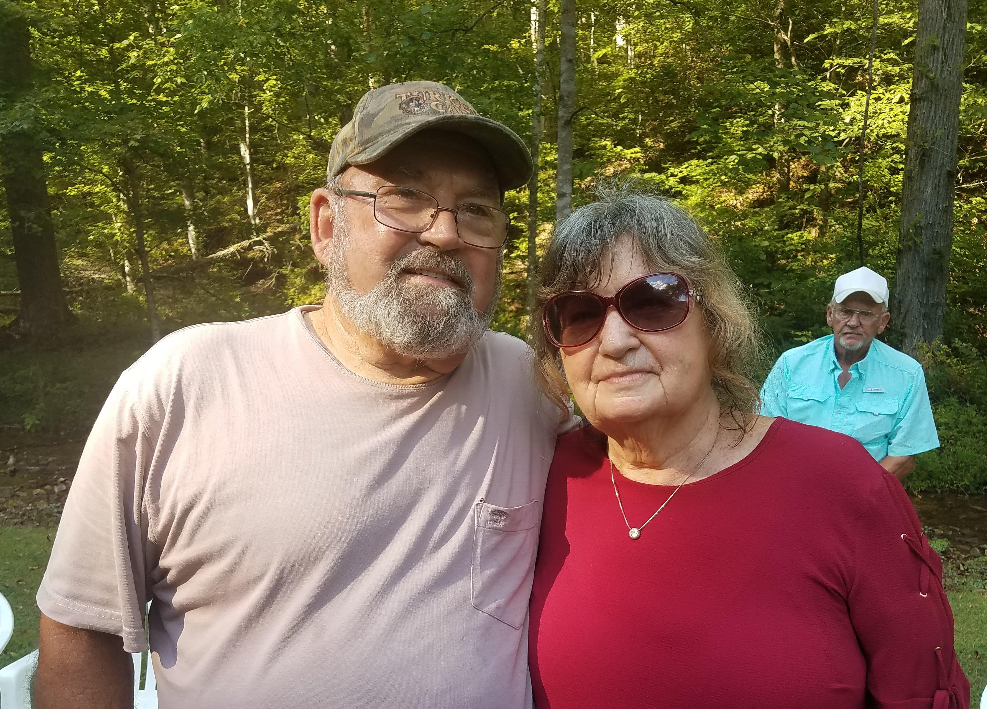 A man and woman standing together outside
