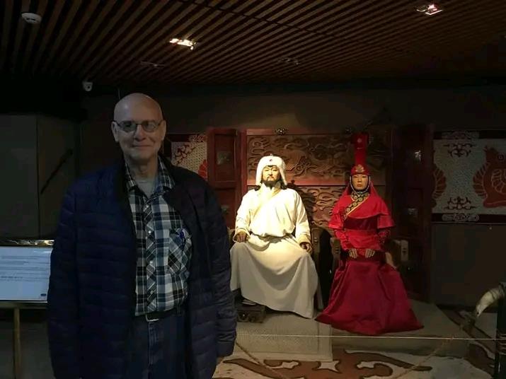 A man standing in front of a group of statues