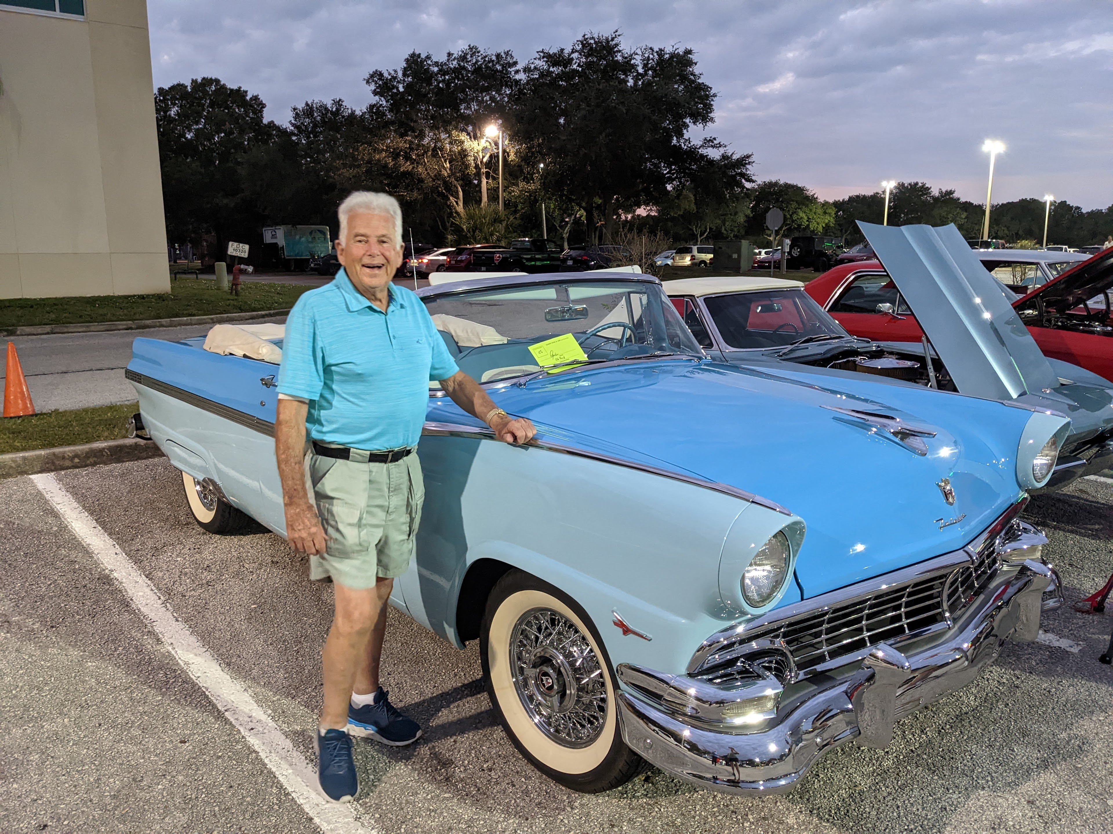 A man standing next to a car