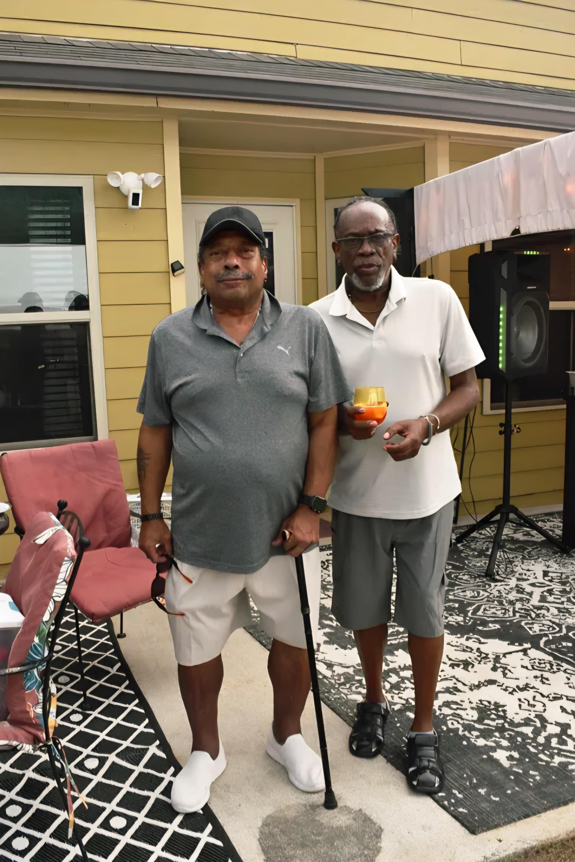 Two men standing in a porch