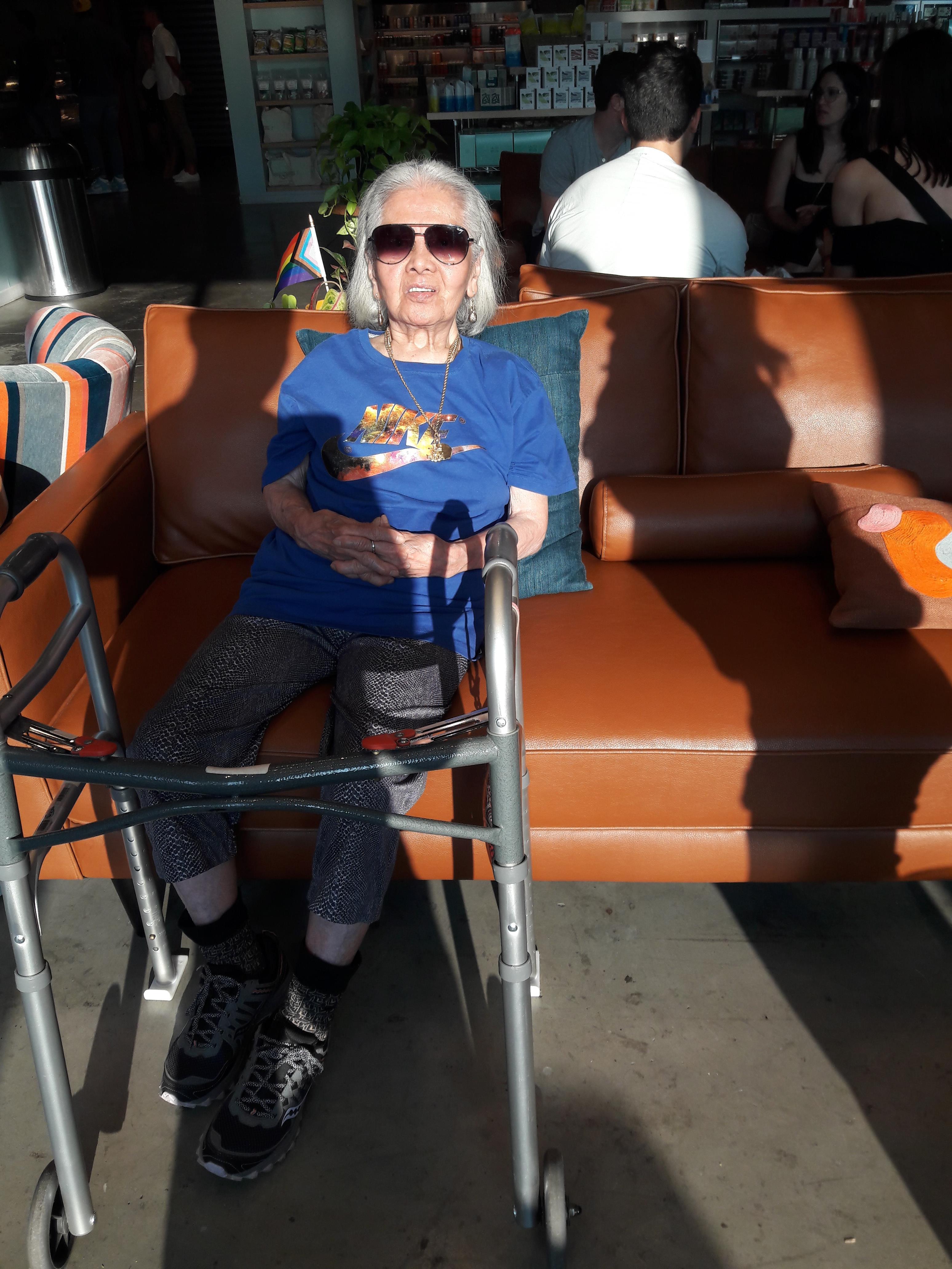 An old woman sitting on a couch
