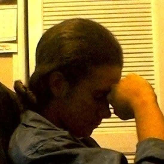 A person with his hand on his forehead