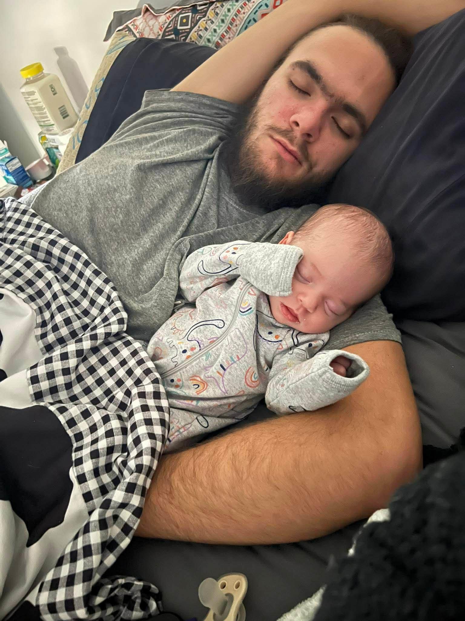 A man sleeping with a baby