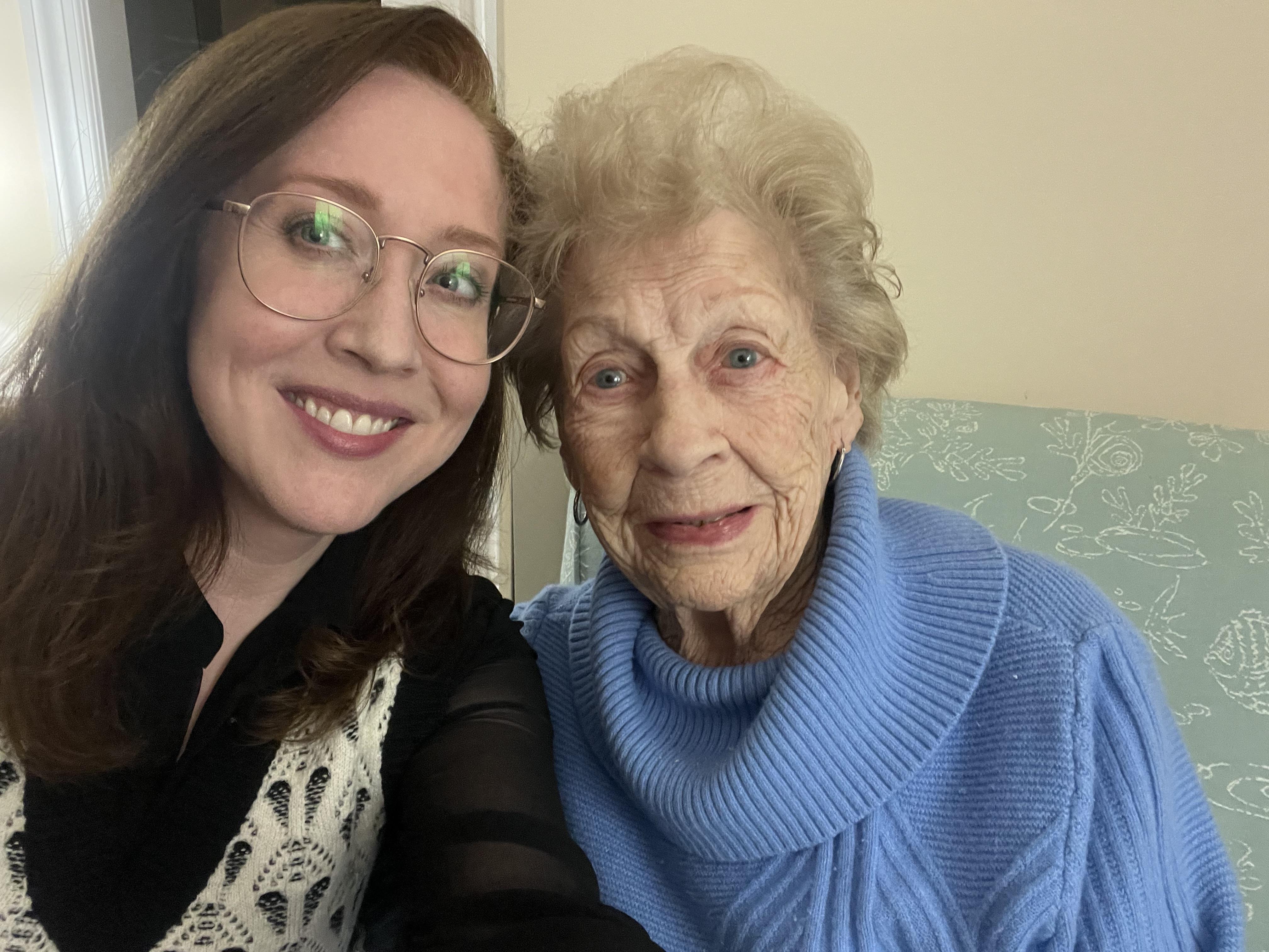 A woman taking a selfie with an old woman