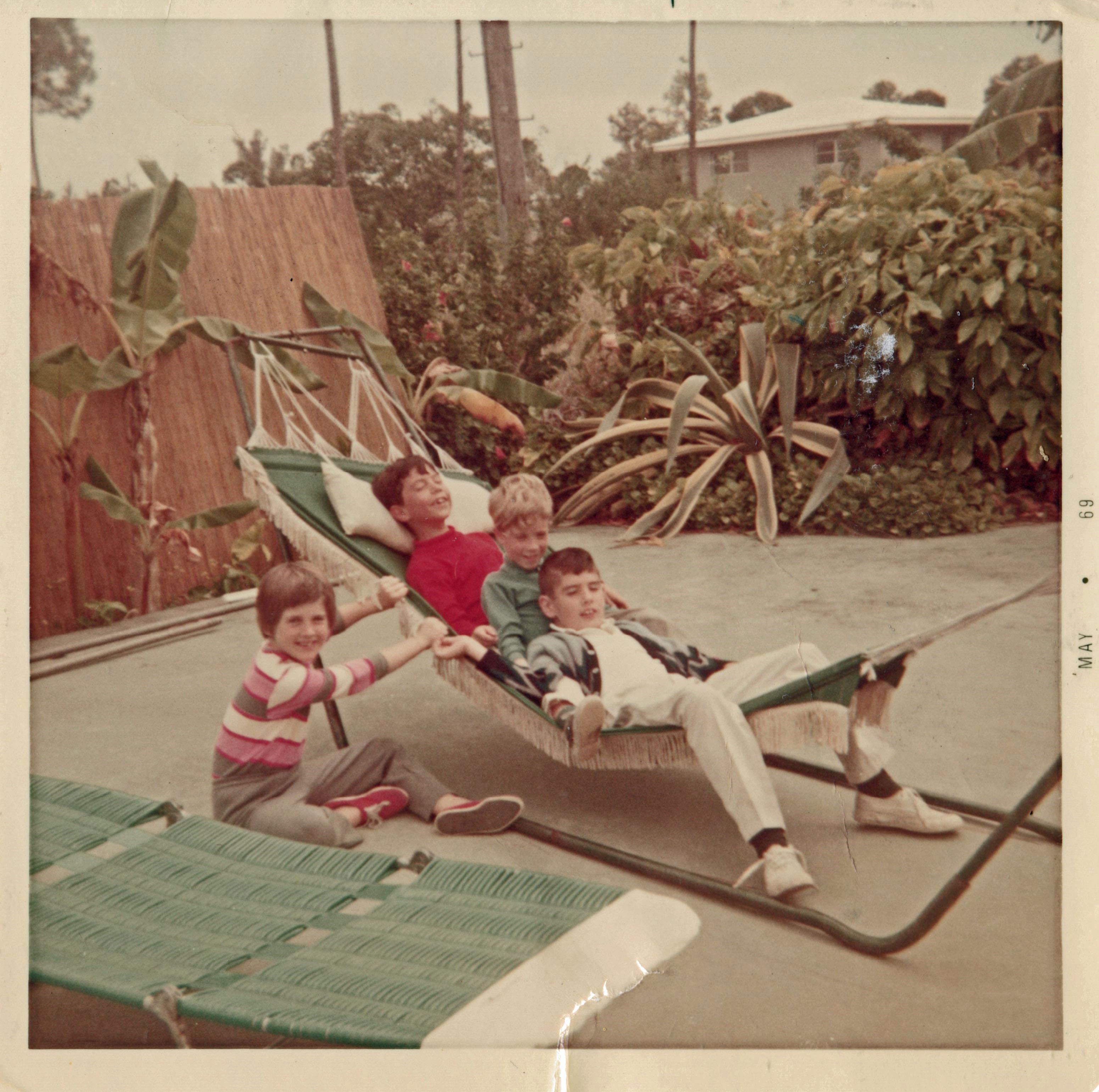 A group of people sitting in a hammock