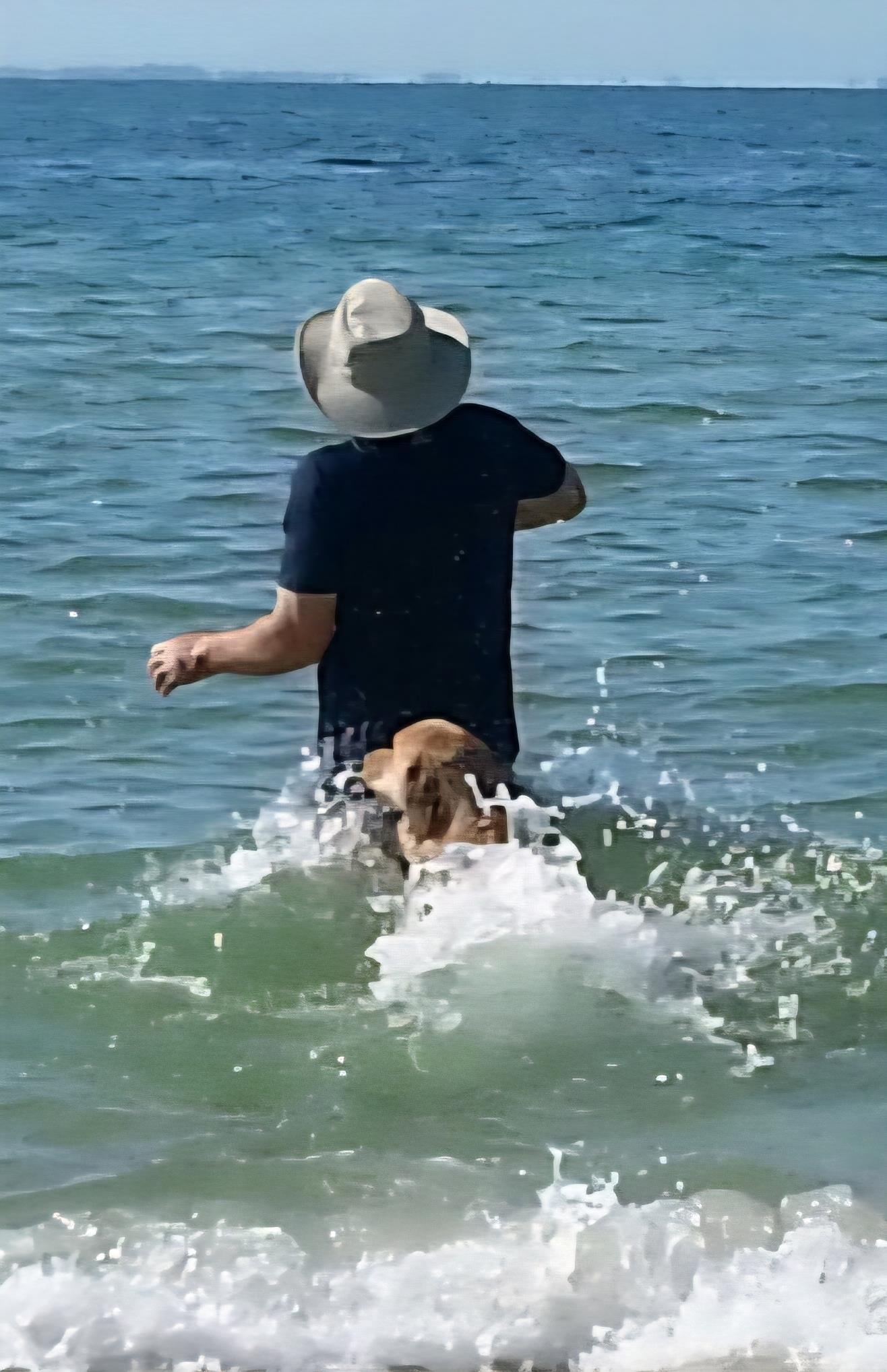 A man and dog in the water