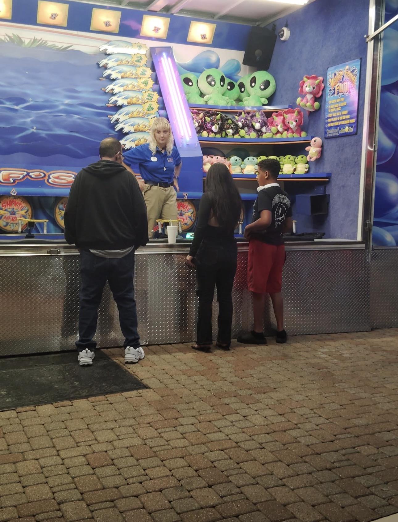 A group of people standing in front of a booth