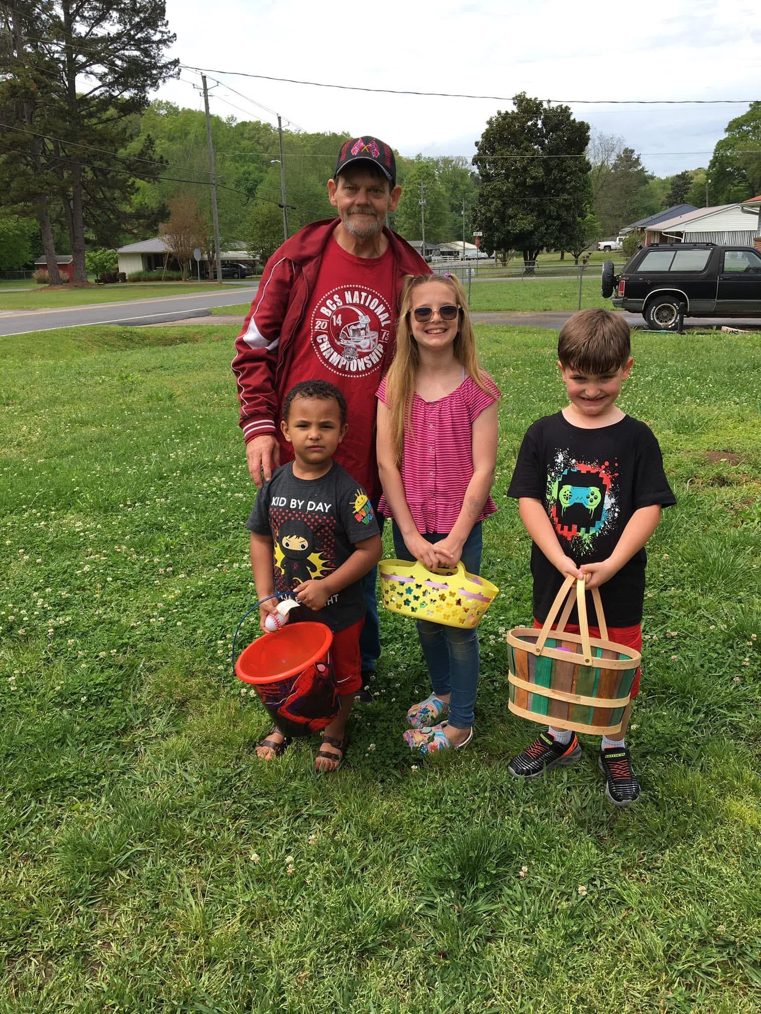 A man and children posing for a picture