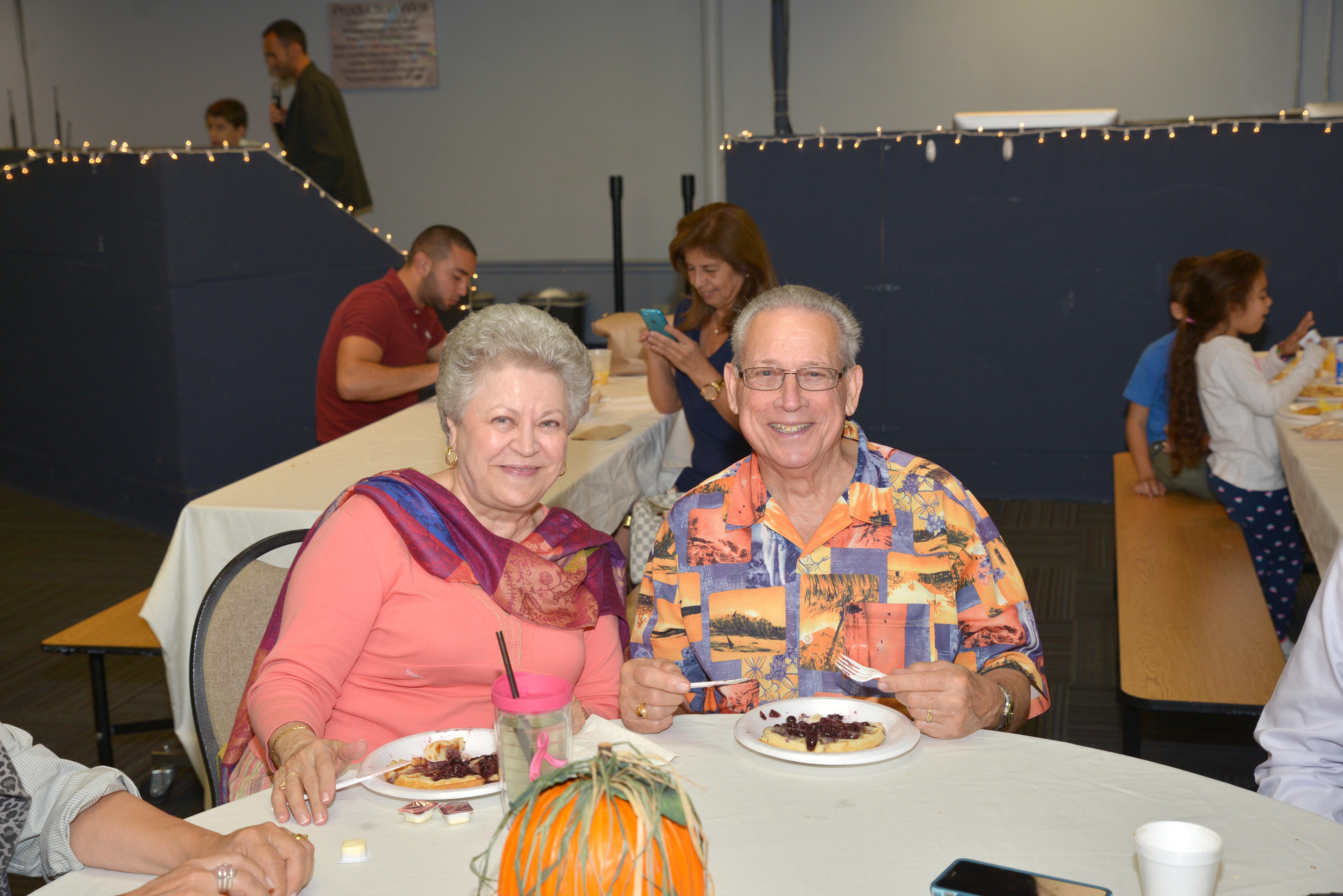 A man and woman sitting at a table
