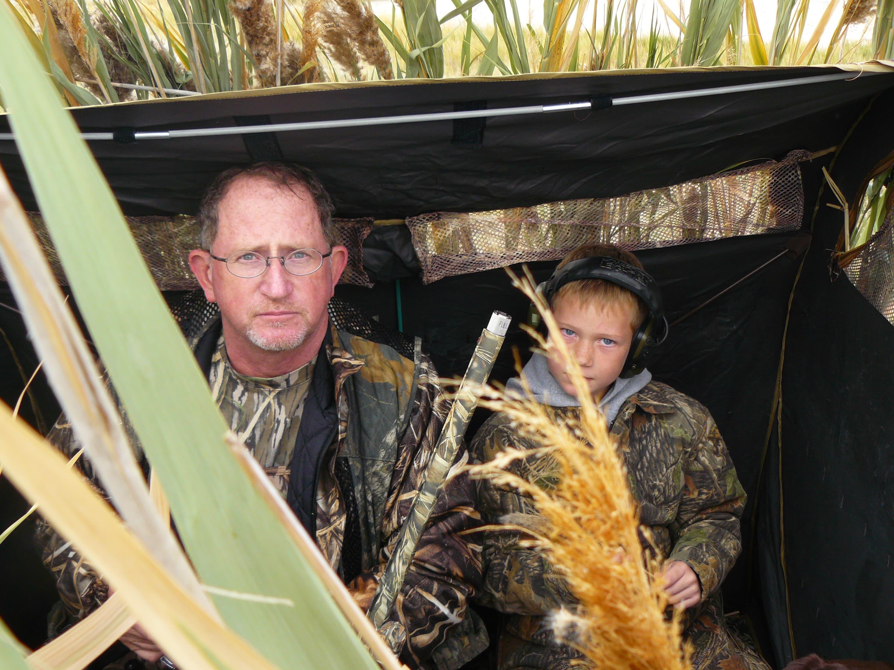 A man and boy in a tent