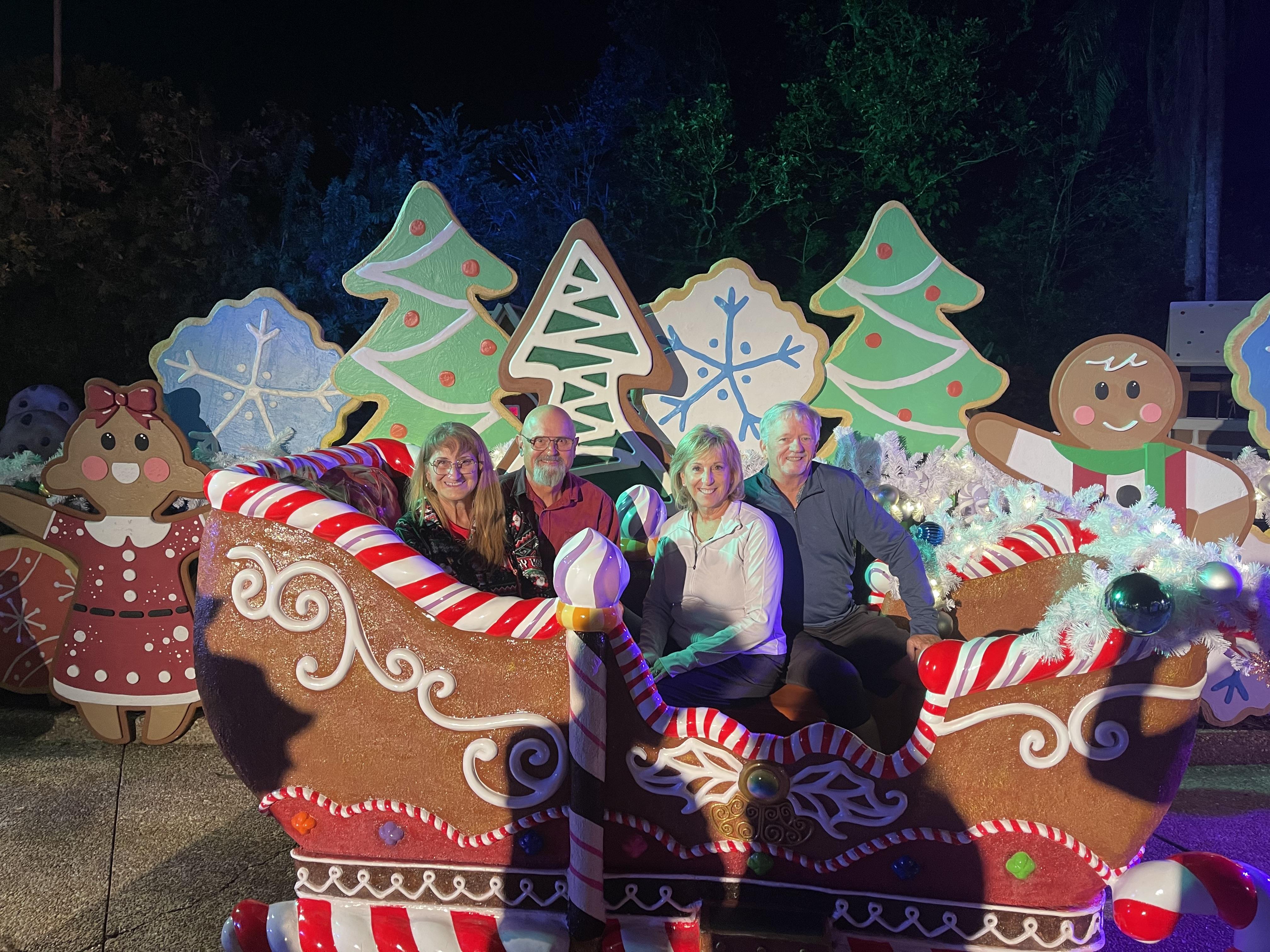 A group of people sitting in a sleigh with decorations