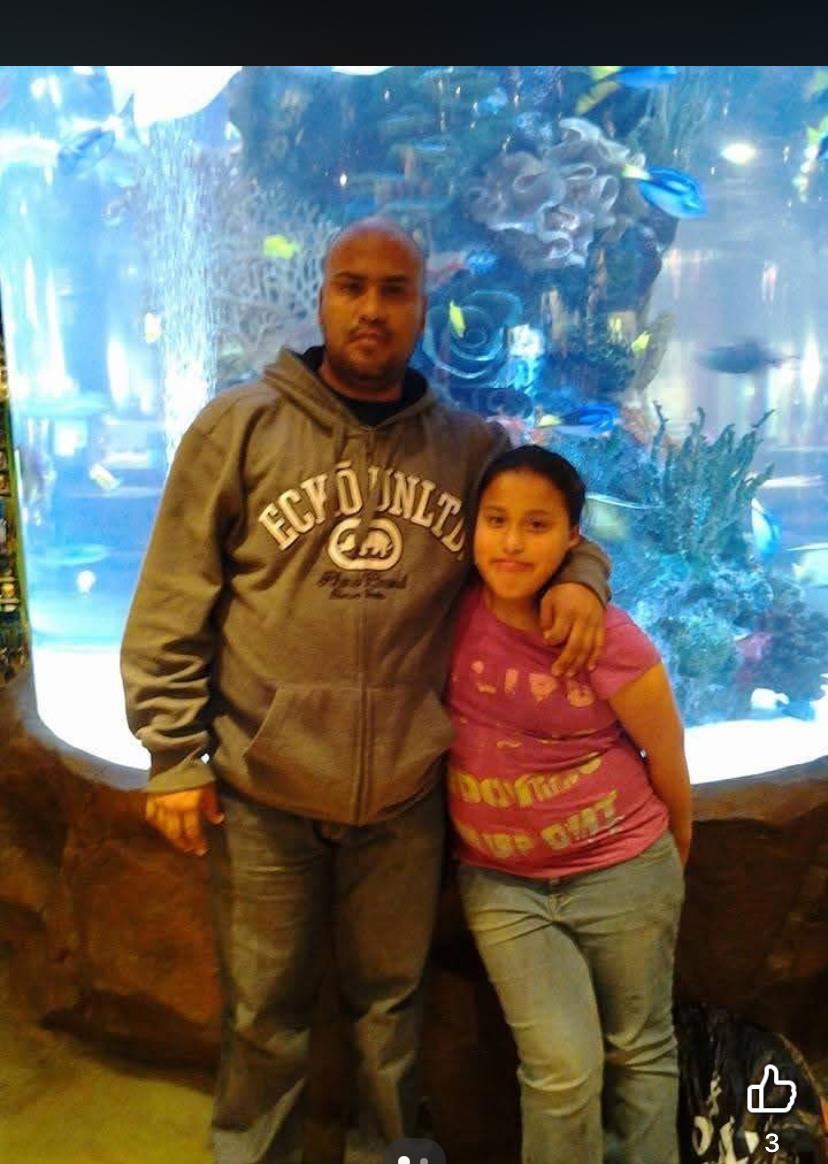 A man and a girl posing for a picture