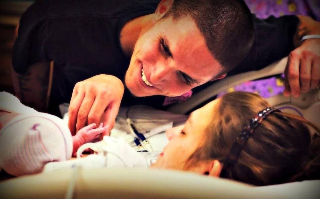 A man looking at a baby