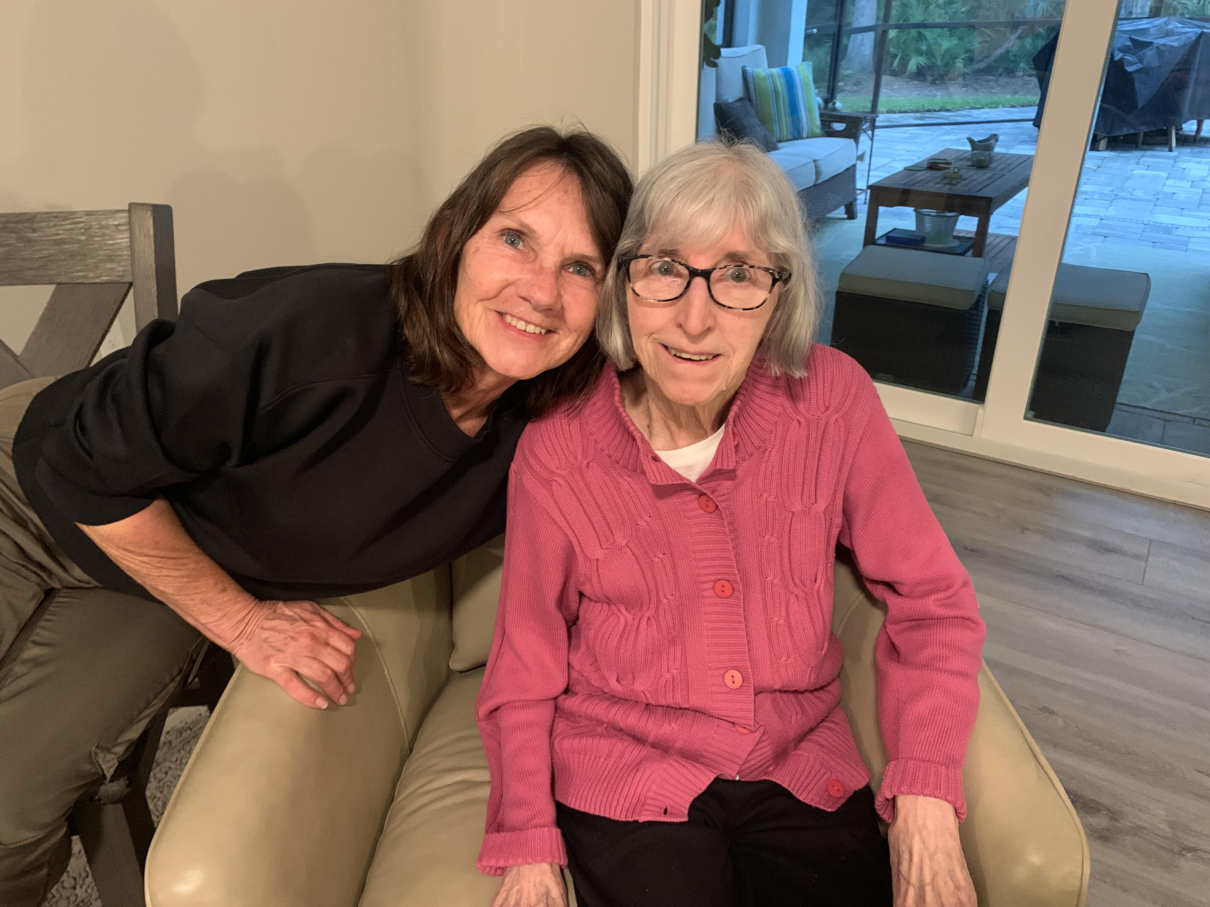Two women sitting on a couch