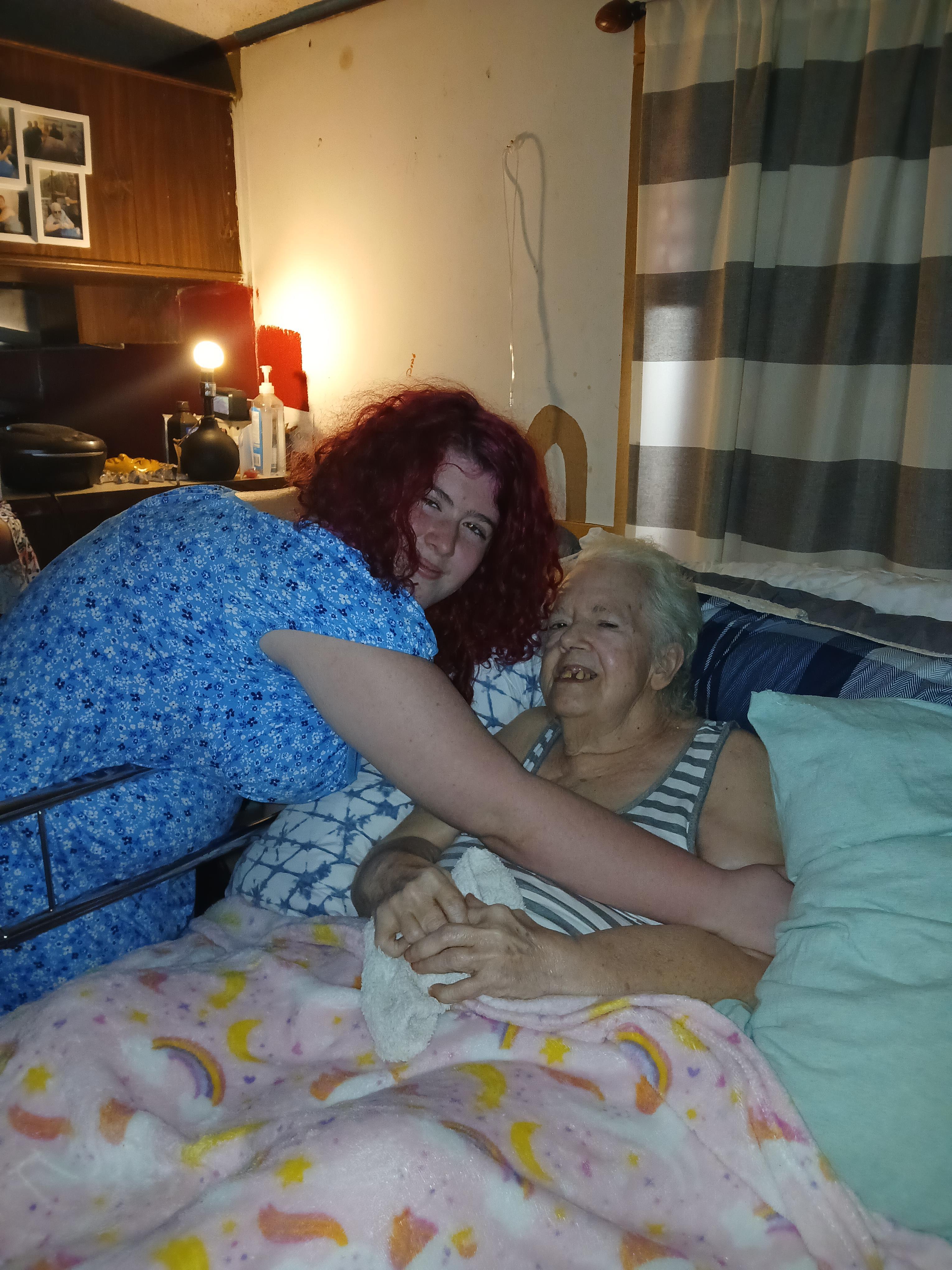 A woman in a hospital bed with an elderly woman