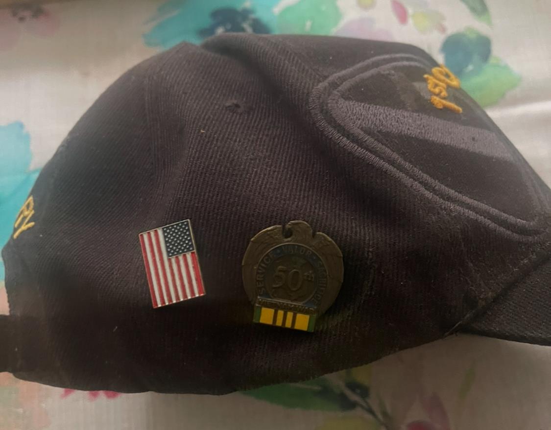 A hat with a flag and pins