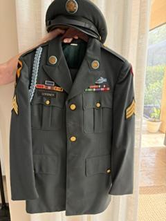 A person holding a military jacket