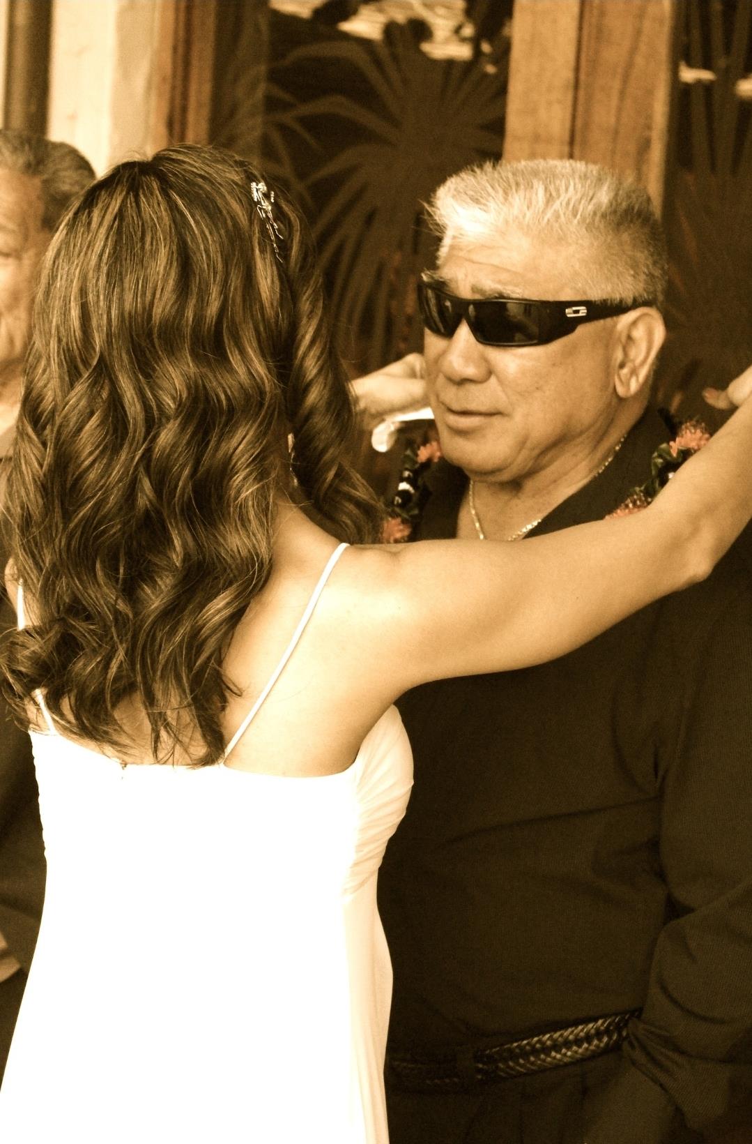 A woman in a white dress and sunglasses