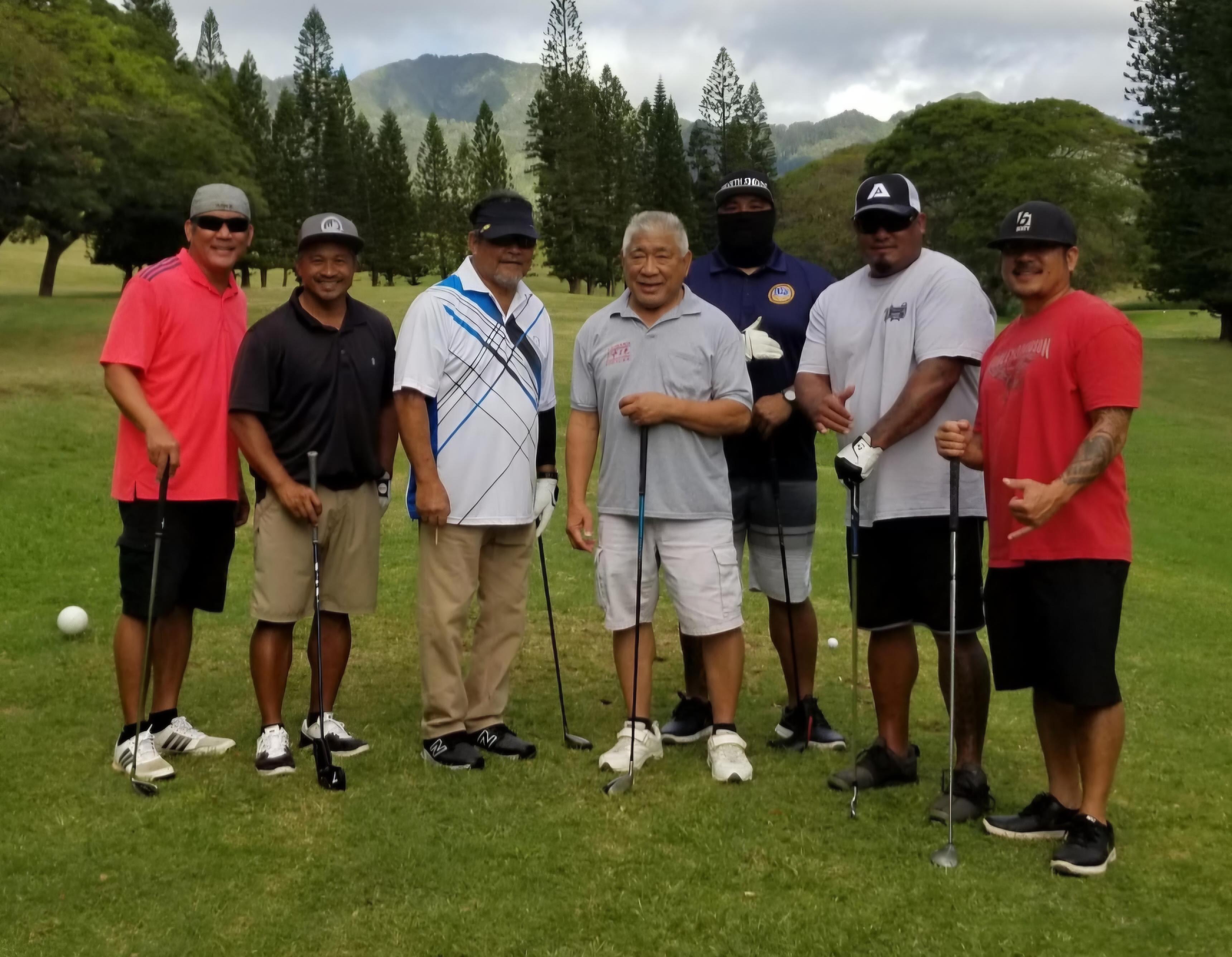 A group of men standing on a golf course