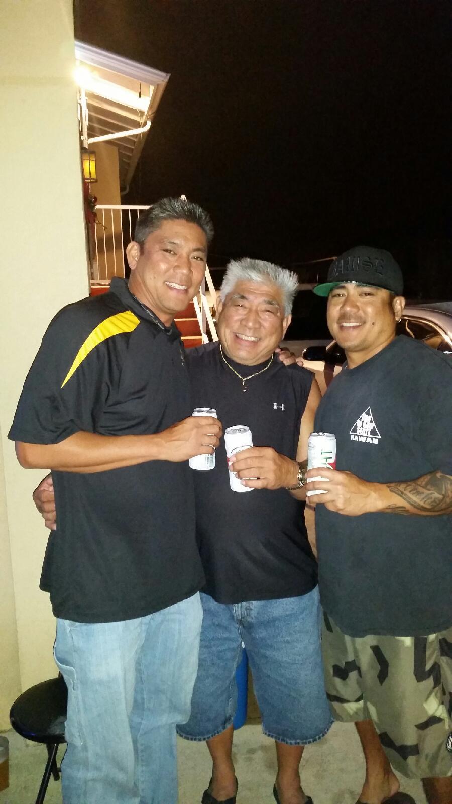 A group of men holding cans