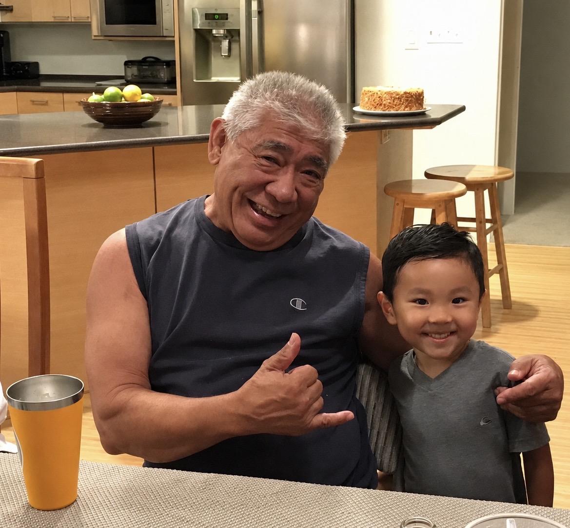 A man and boy sitting at a table