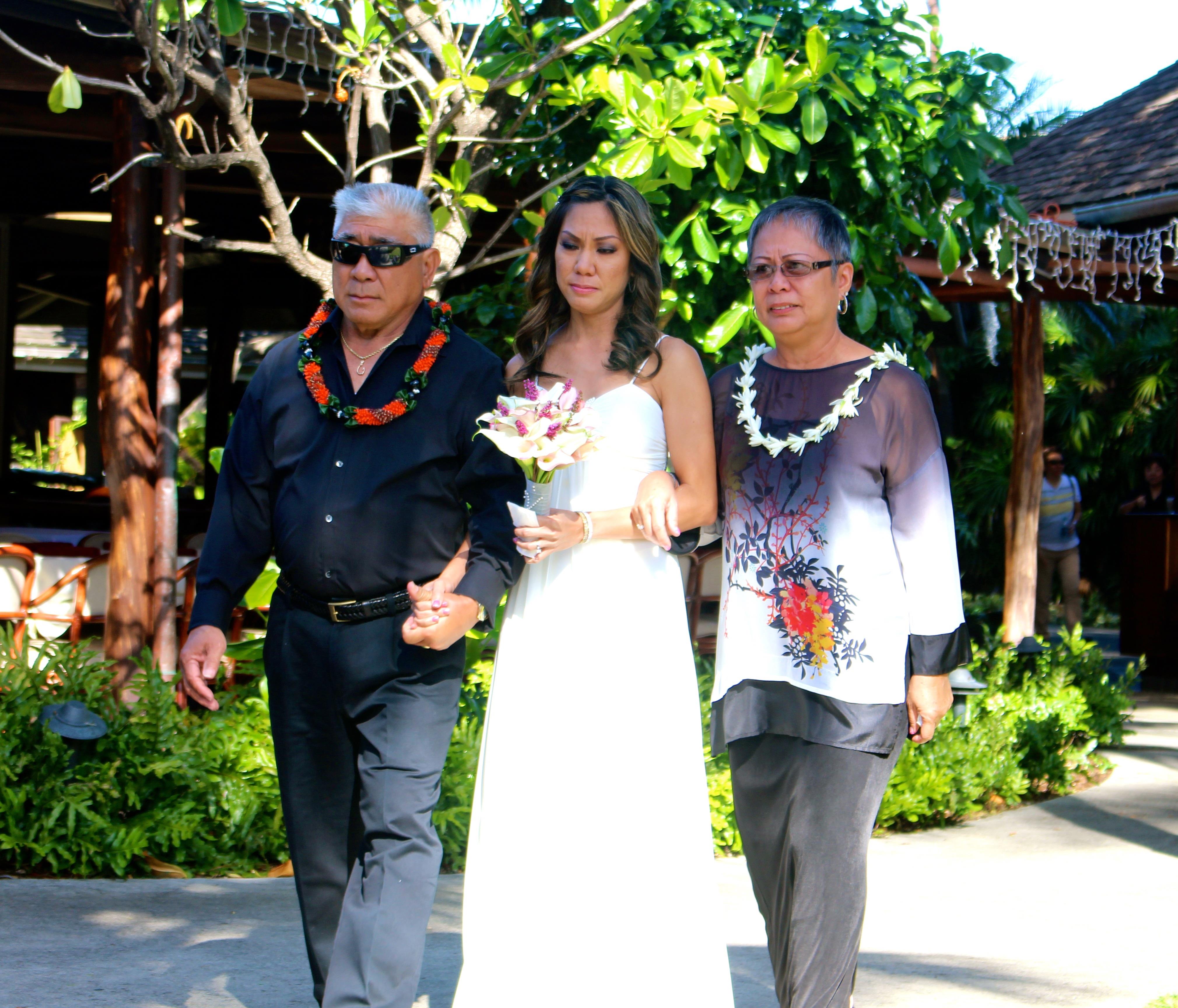 A man and woman walking down a sidewalk