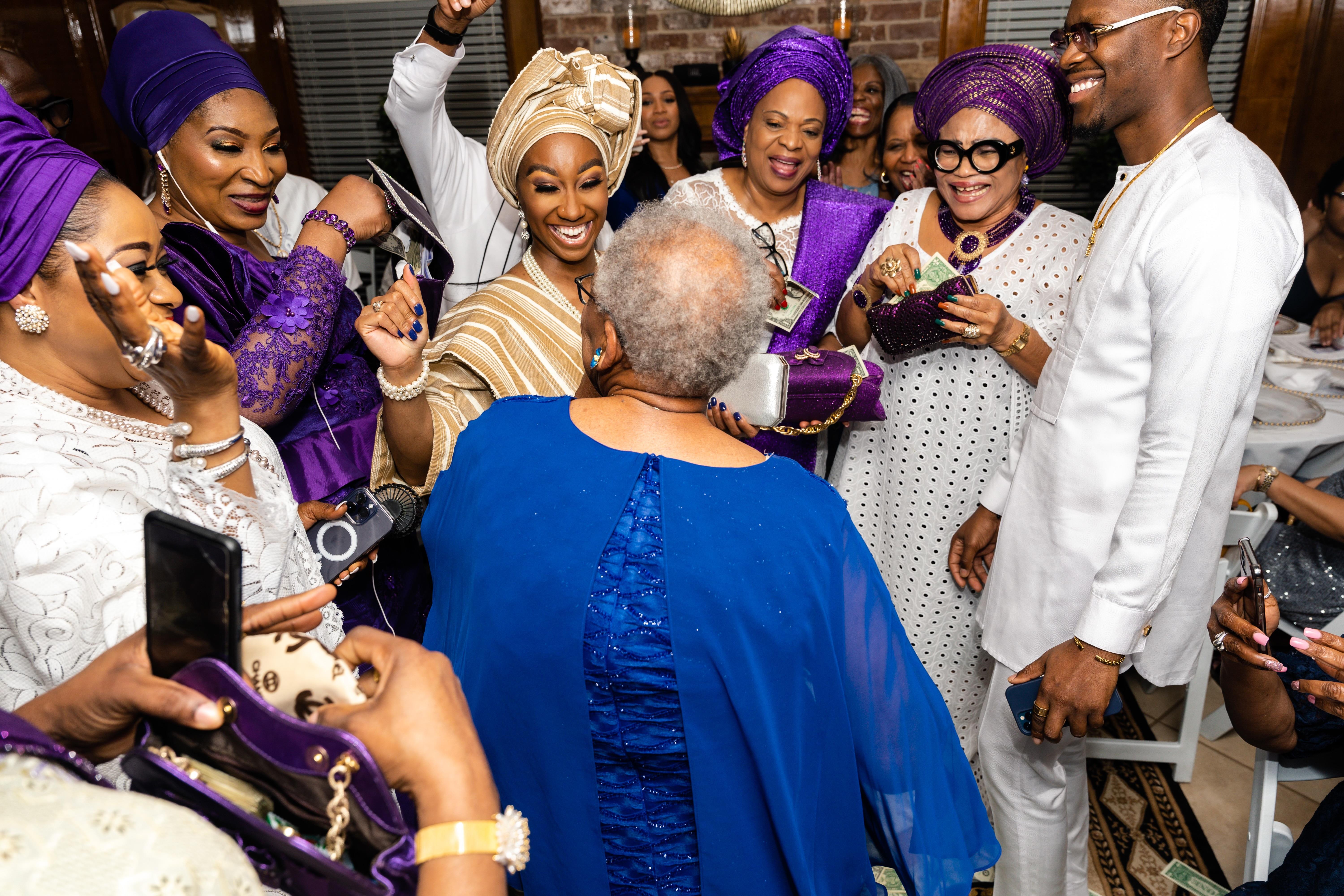 A group of people in white and purple dresses