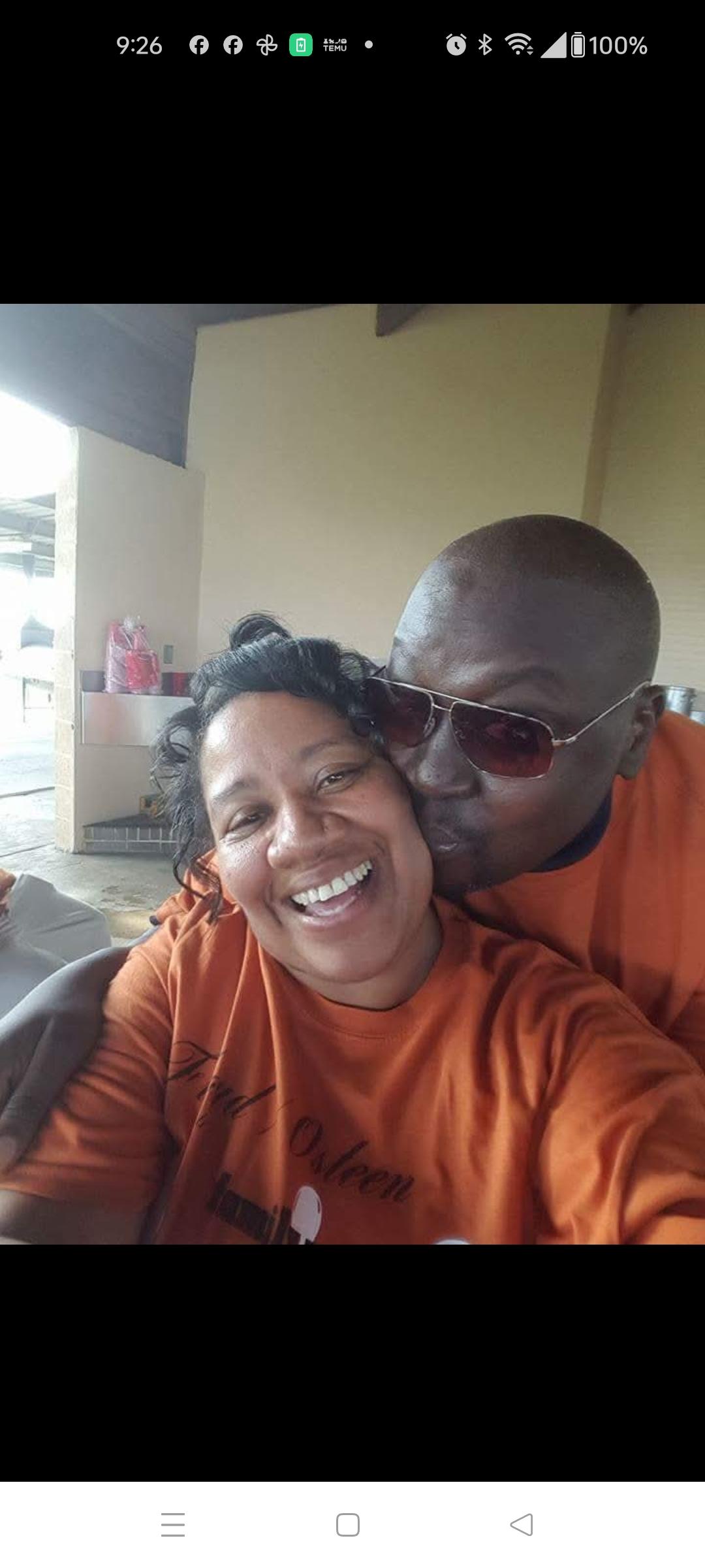 A man kissing a woman's cheek