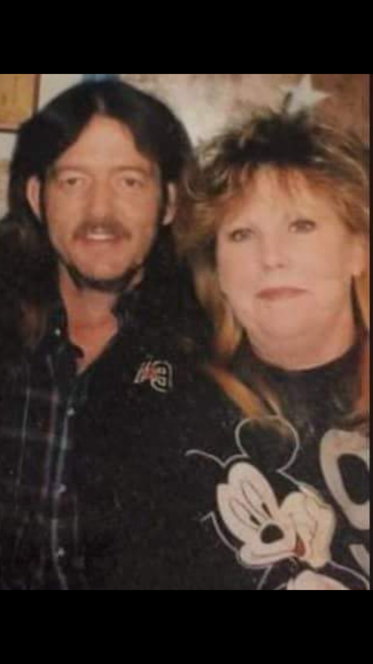A man and woman posing for a picture