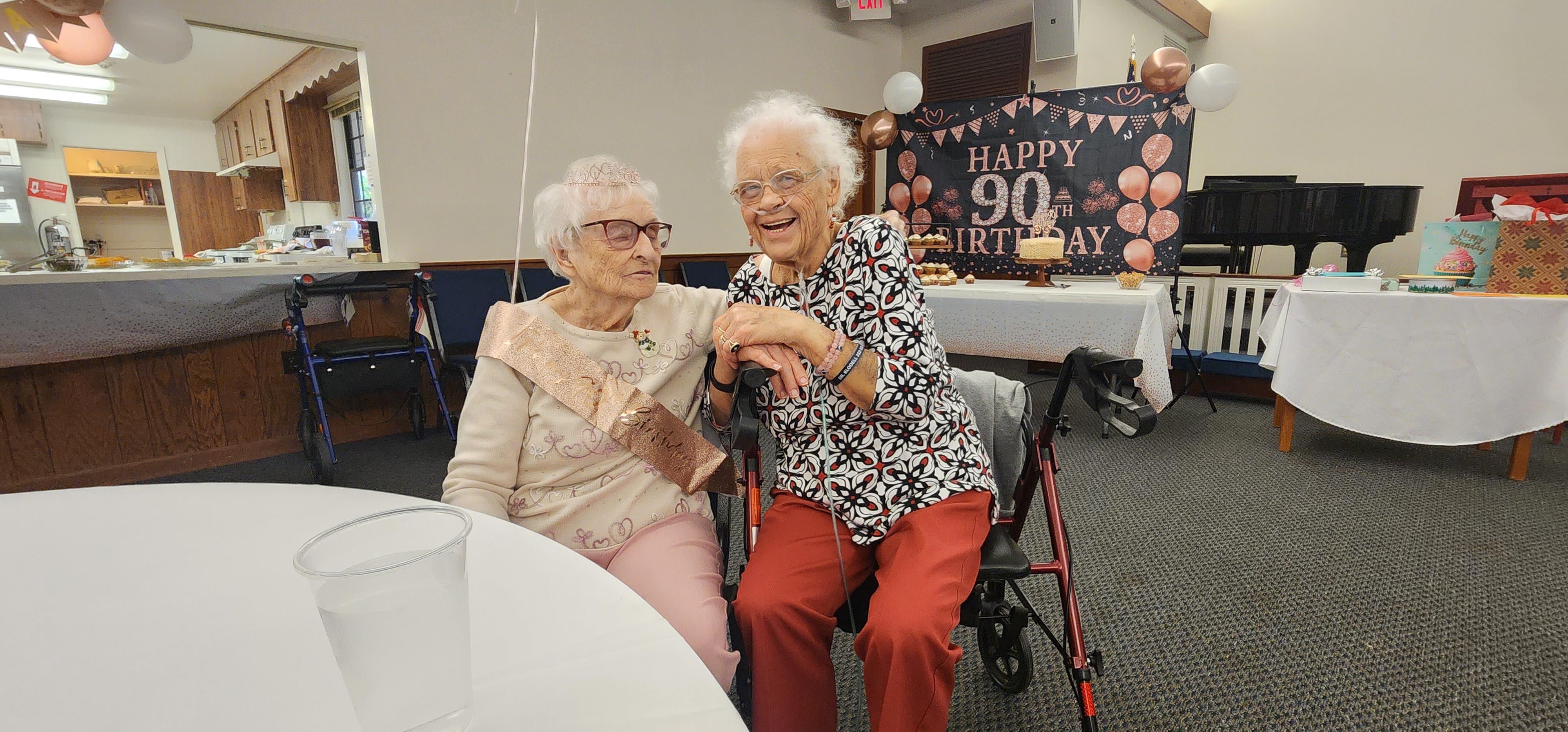 Two women sitting in a wheelchair