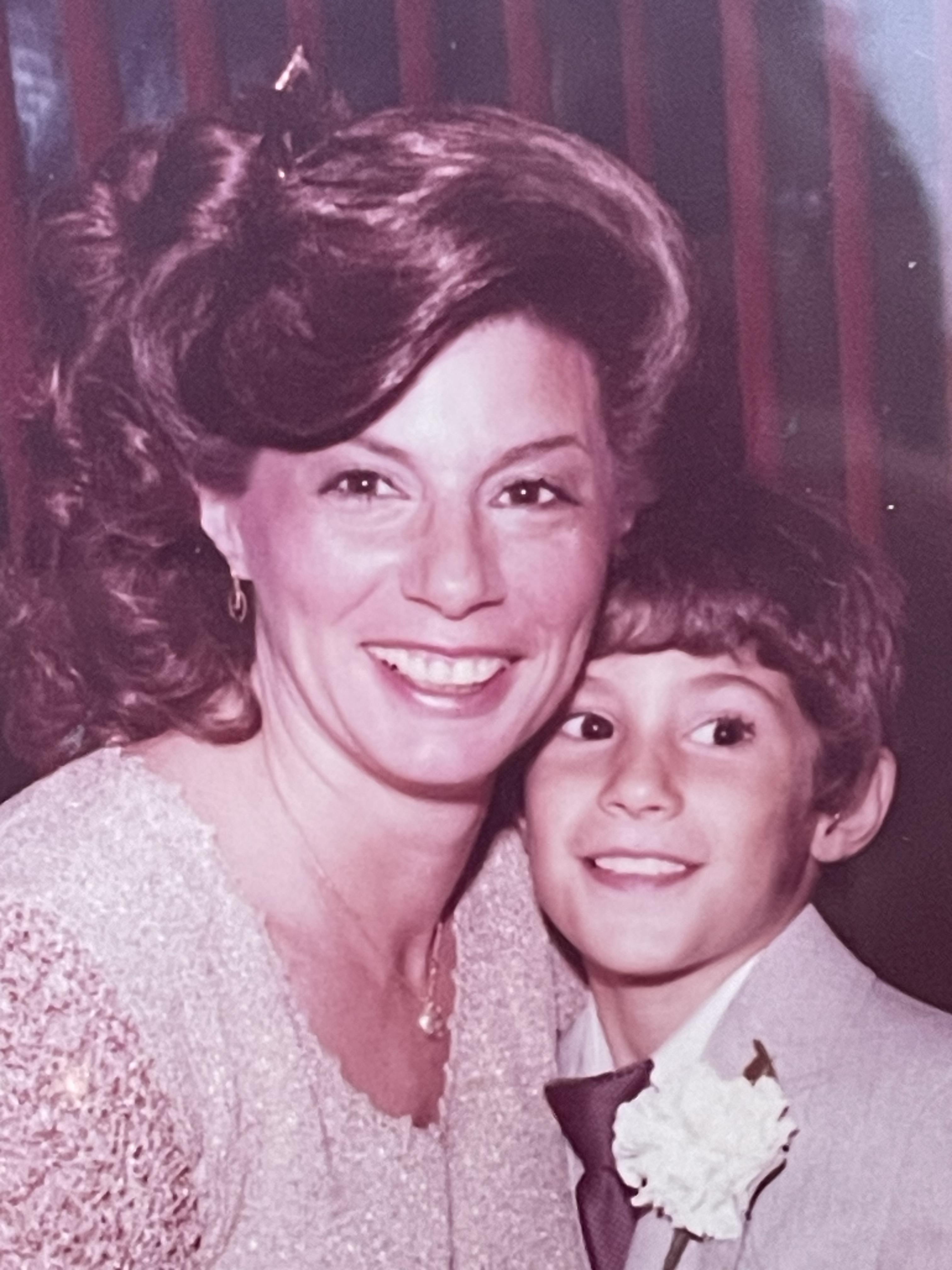A woman and a boy posing for a picture