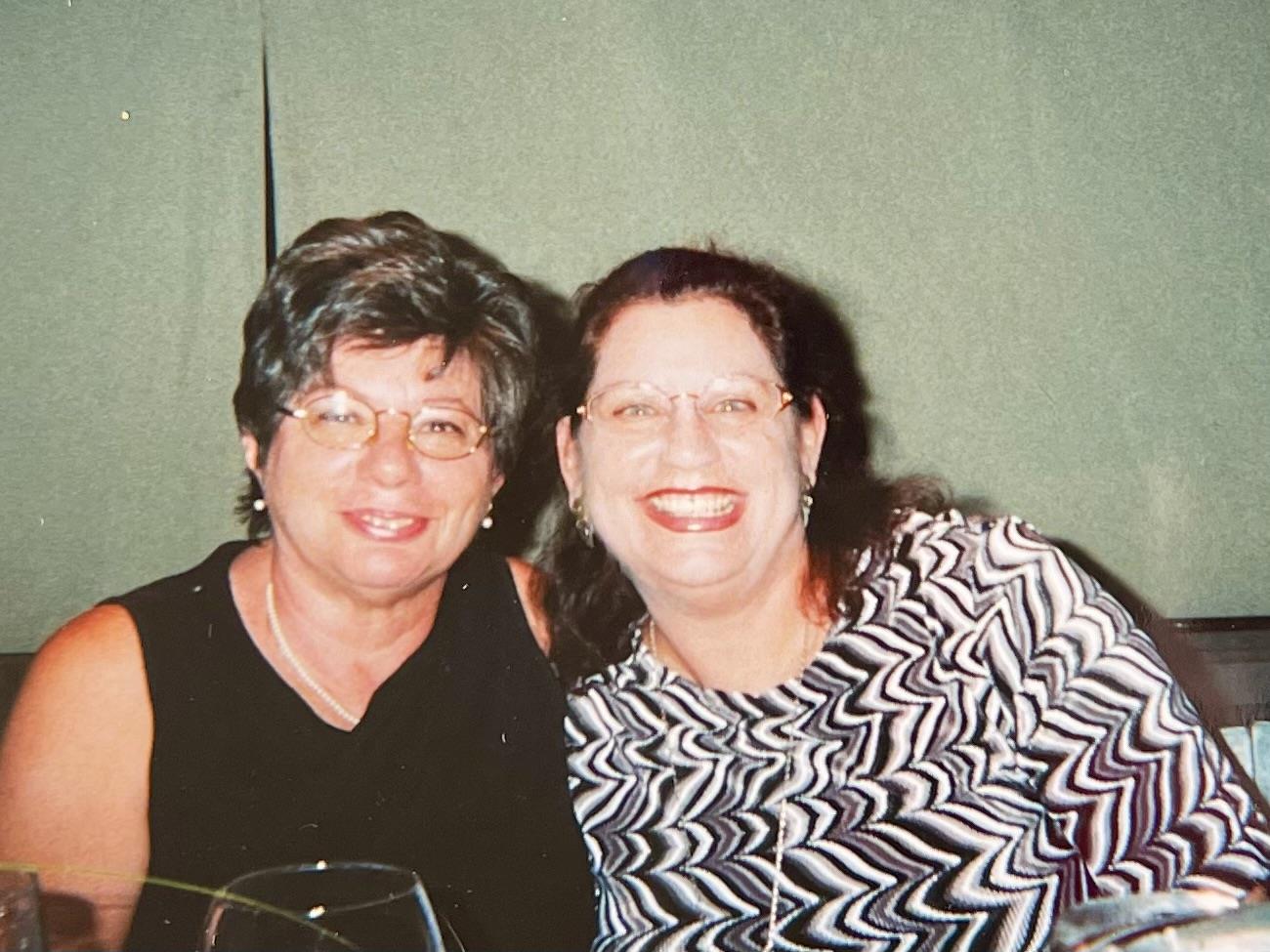 A couple of women smiling at the camera
