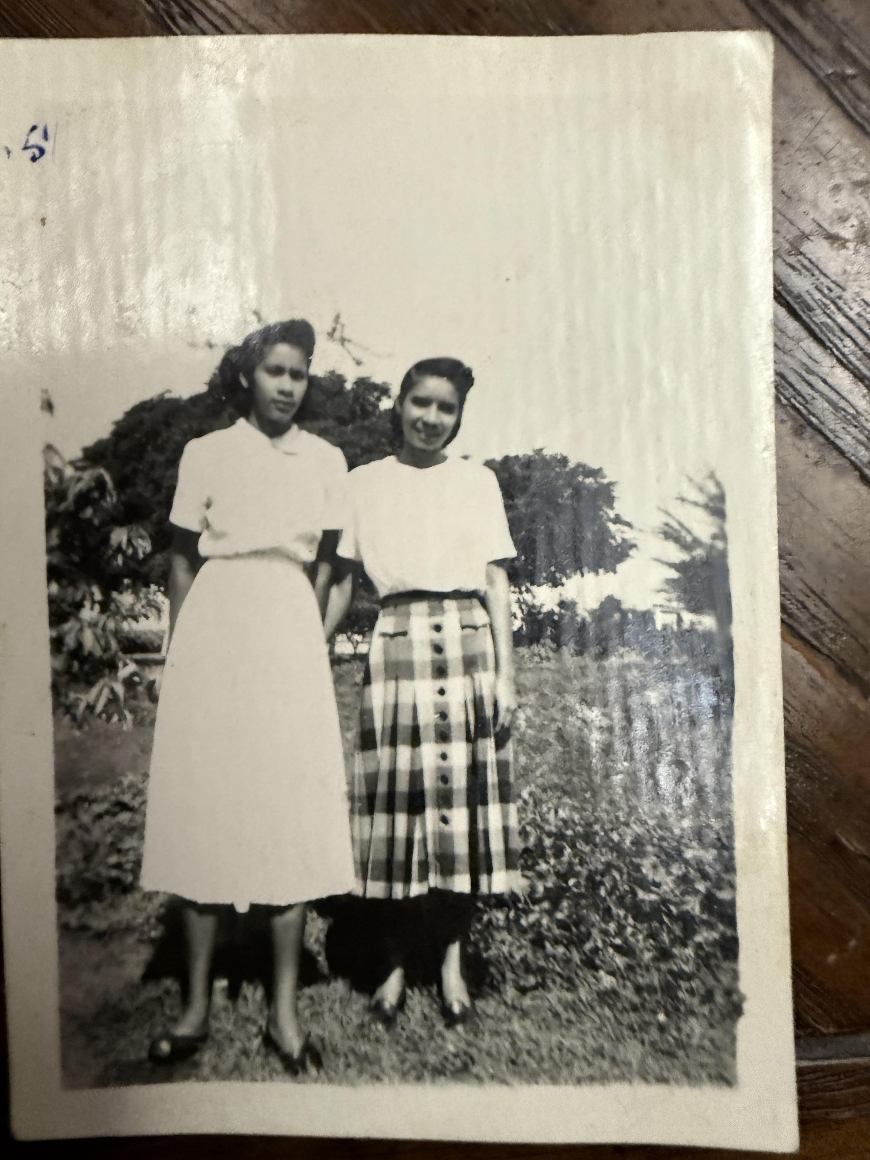 A black and white photo of two girls