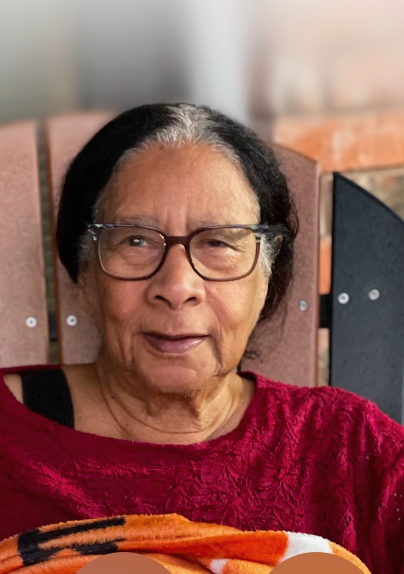 A woman wearing glasses and a red shirt
