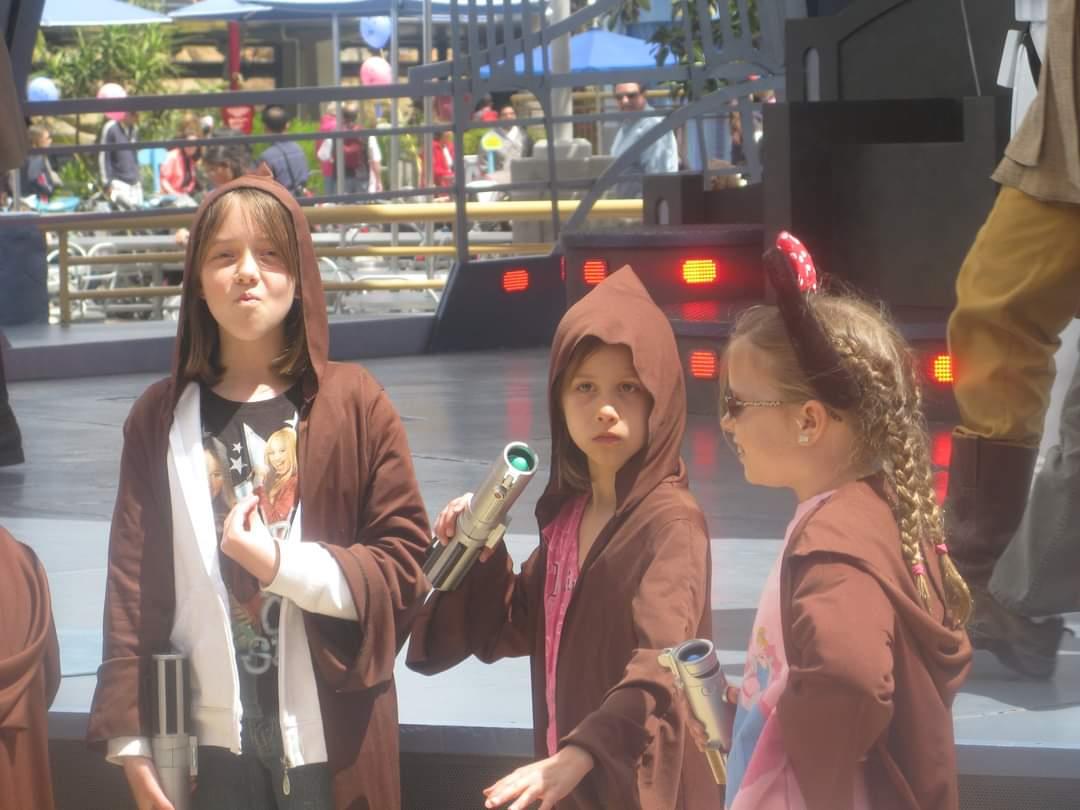 A group of young girls wearing brown hoods