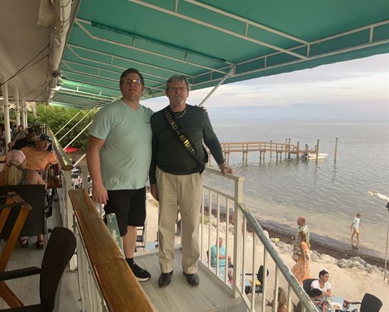 Two men standing on a balcony