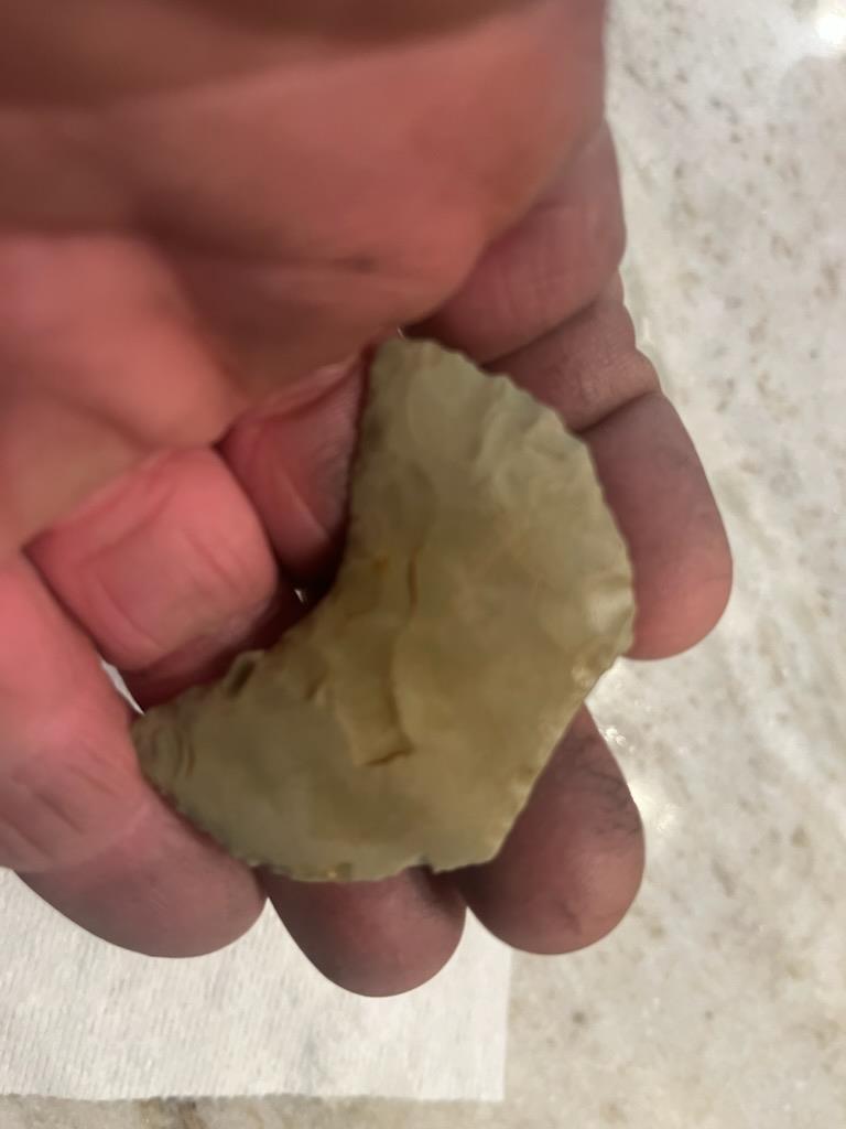 A person holding a piece of food