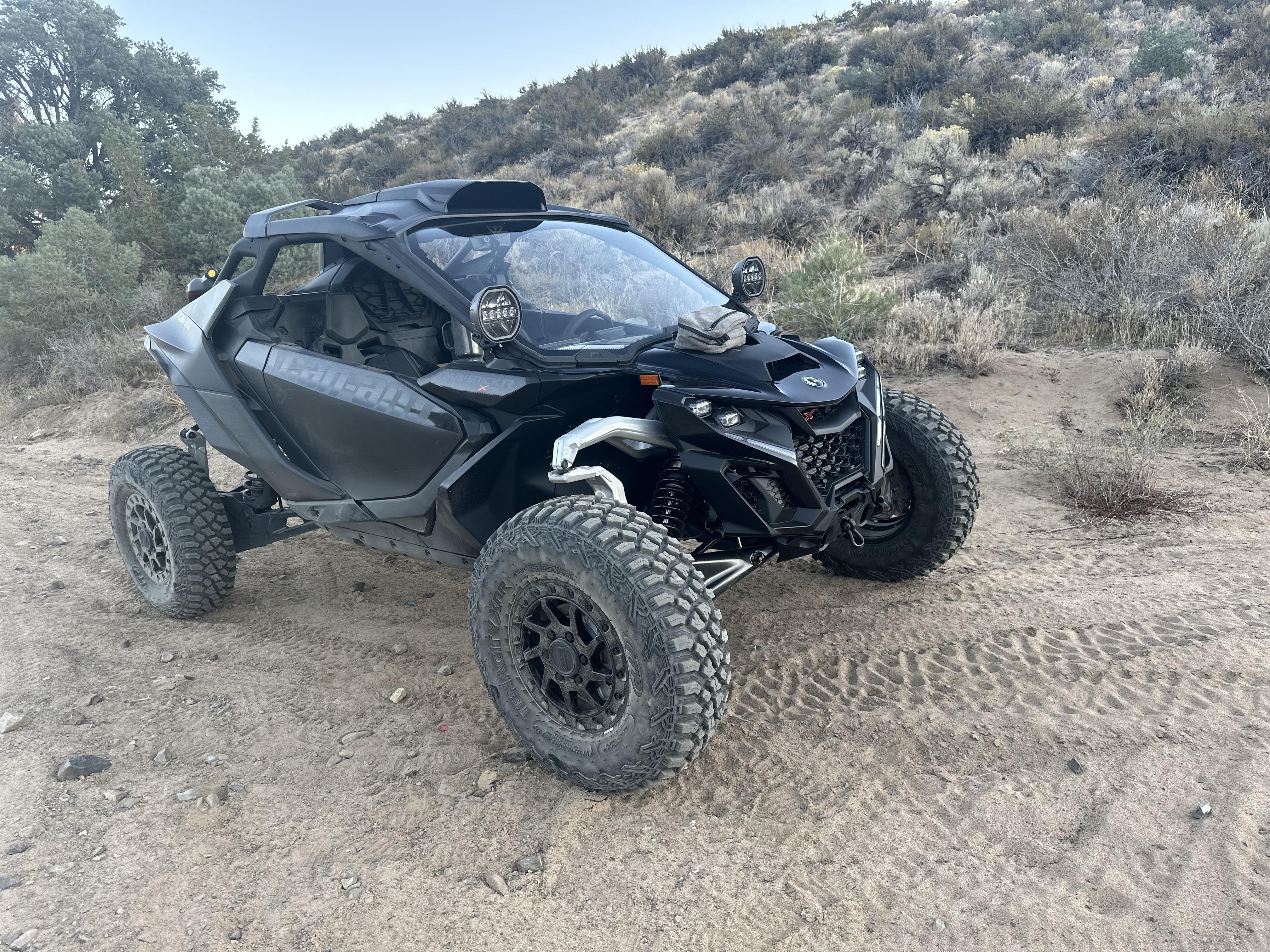 A black vehicle on a dirt road