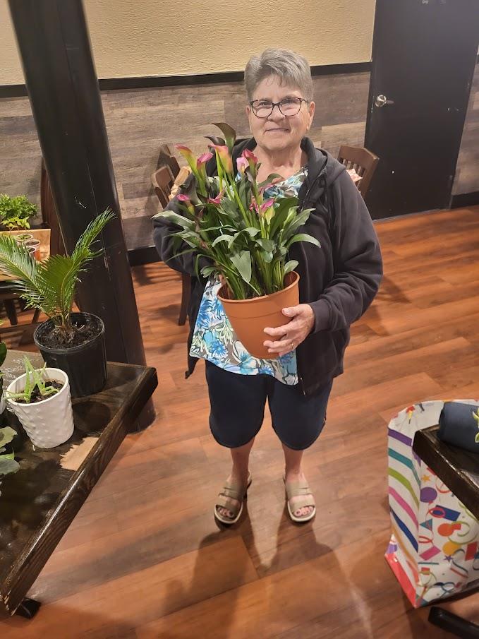 A woman holding a potted plant