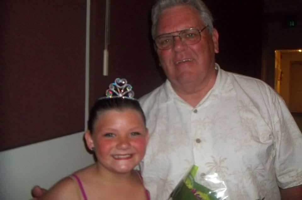 A man and a girl posing for a picture