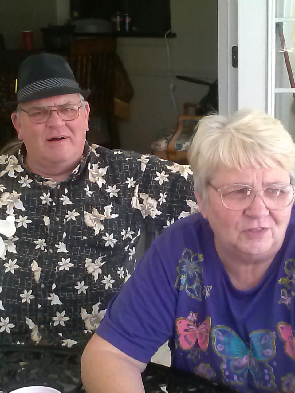 A man and woman sitting in a chair