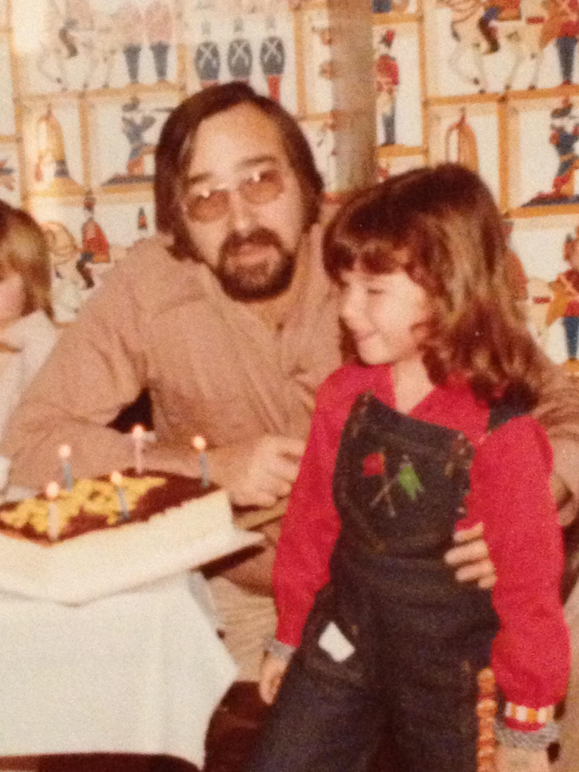 A man and child sitting in front of a cake